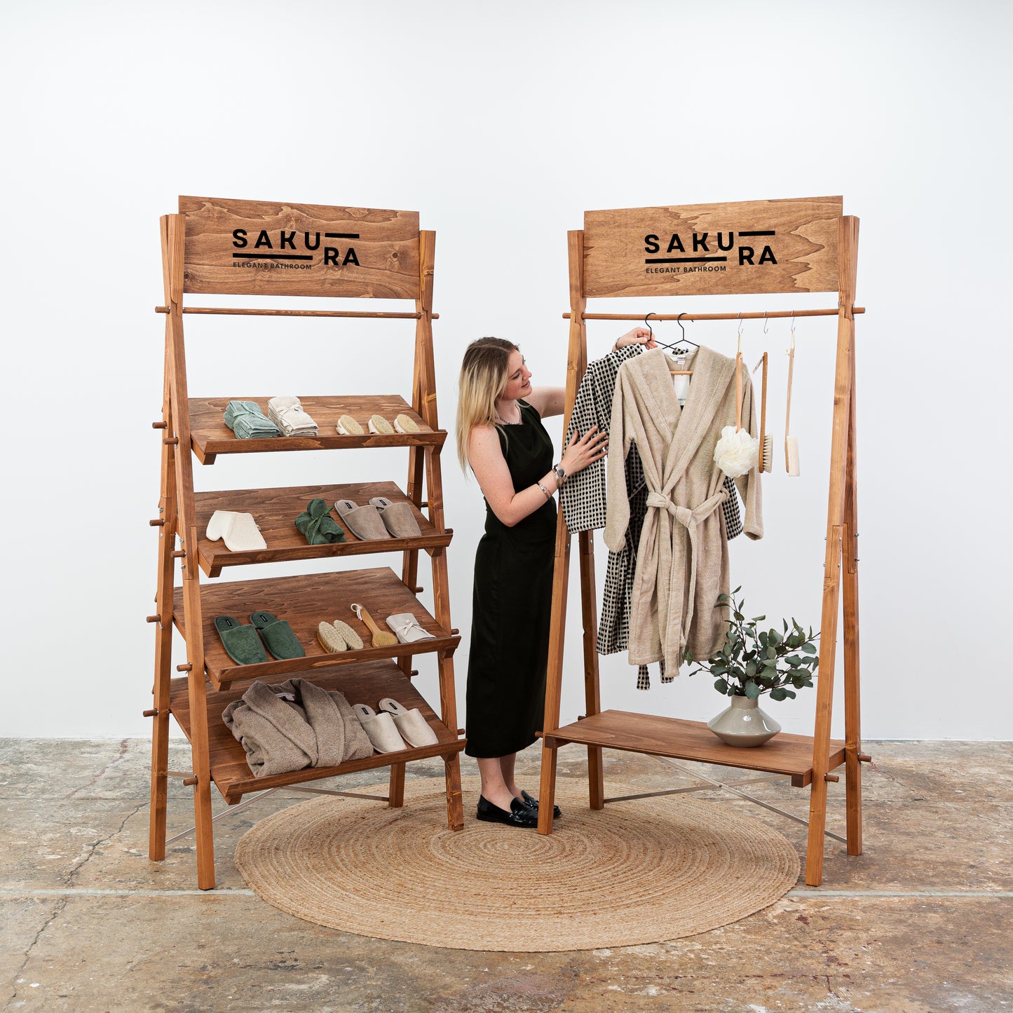 Wooden display set with slanted shelving and clothing rack for trade fairs