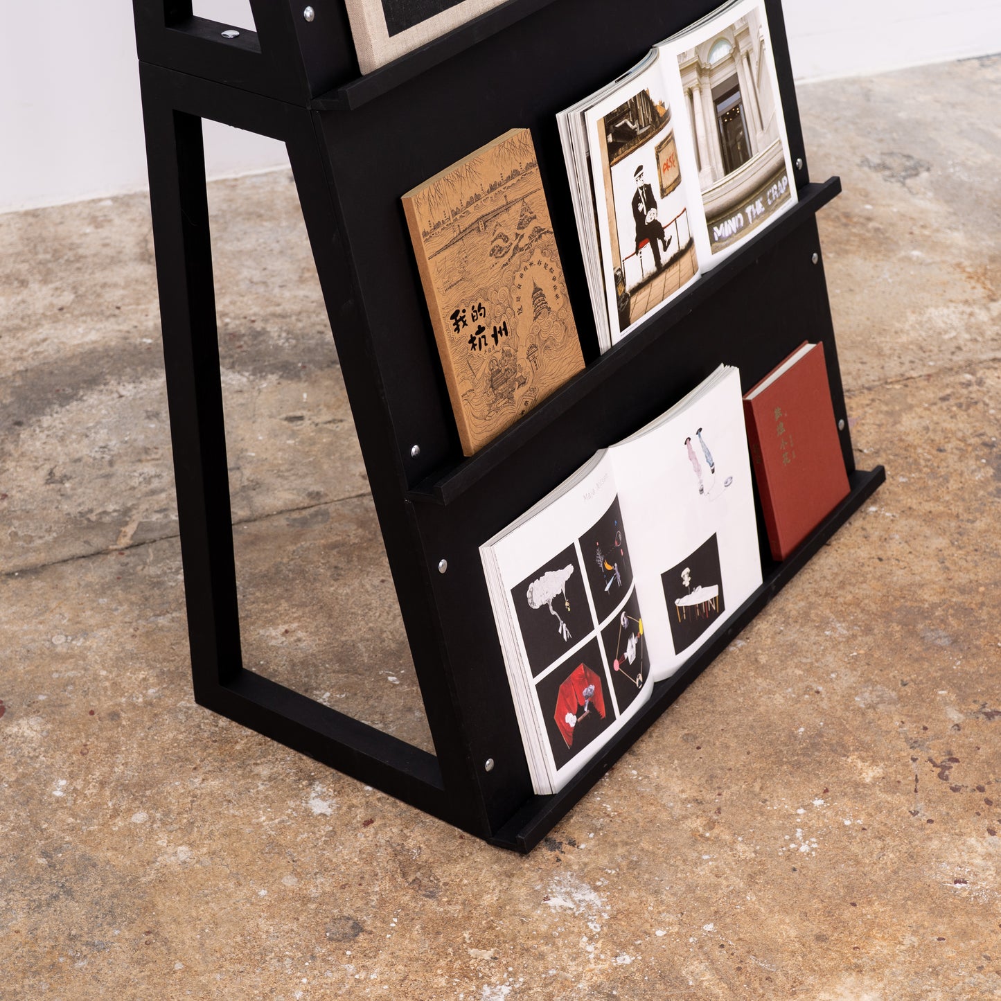 Foldable magazine stand used as one wide unit with angled tiers