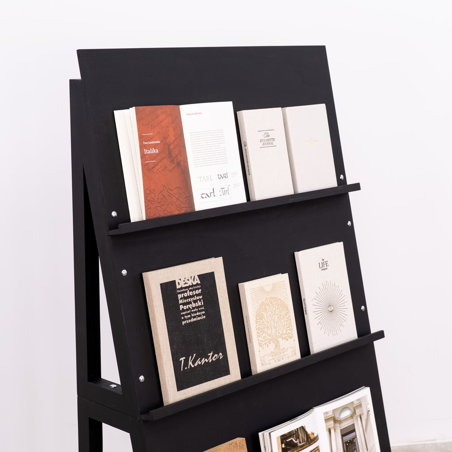 Portable black wood stand with magazine covers on display