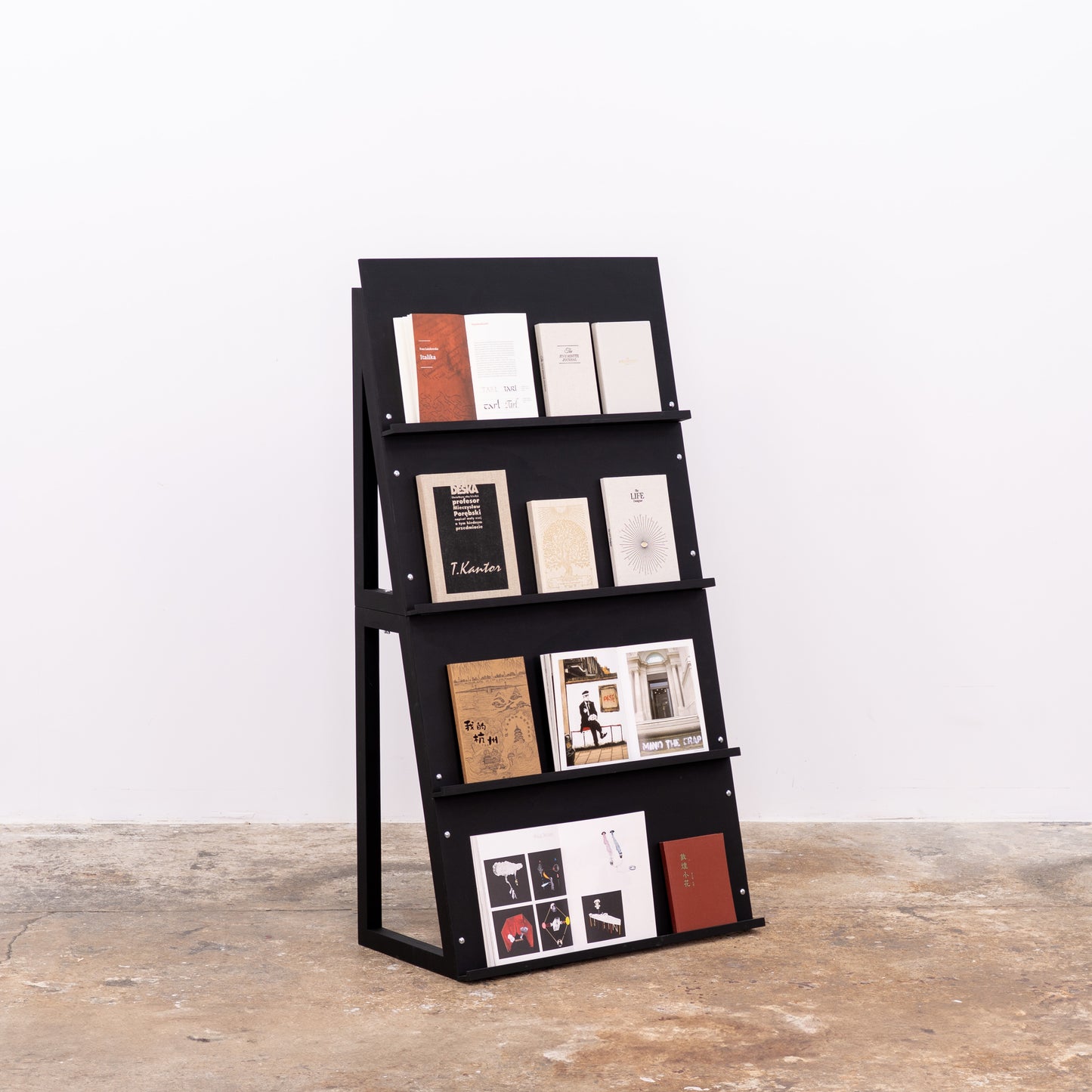 Two-part matte black shelving for notebooks and print presentation