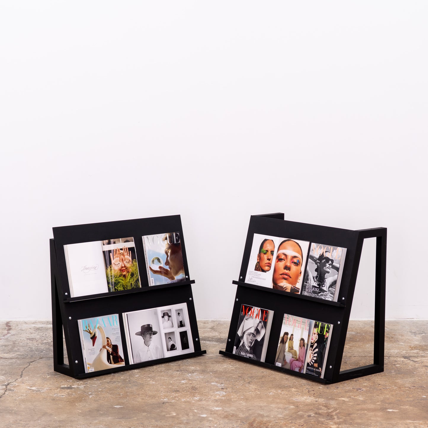 Dual black magazine display stand used in a mobile event setup