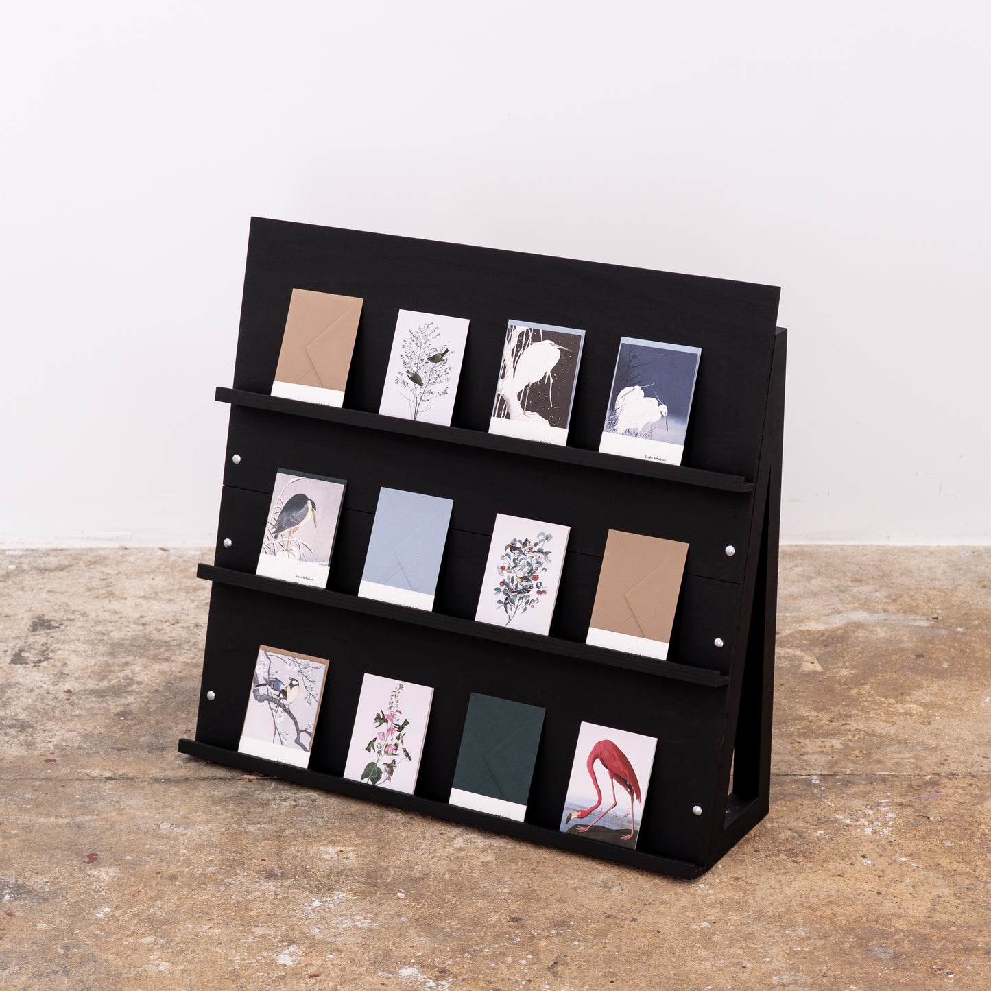 Compact foldable shelf in black, ideal for print products