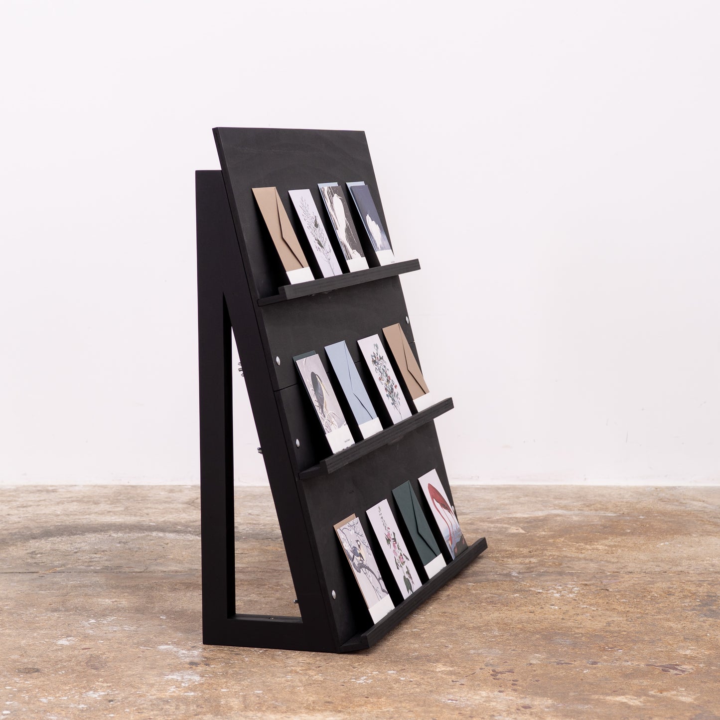 Foldable black display unit with custom minimalist stationery setup