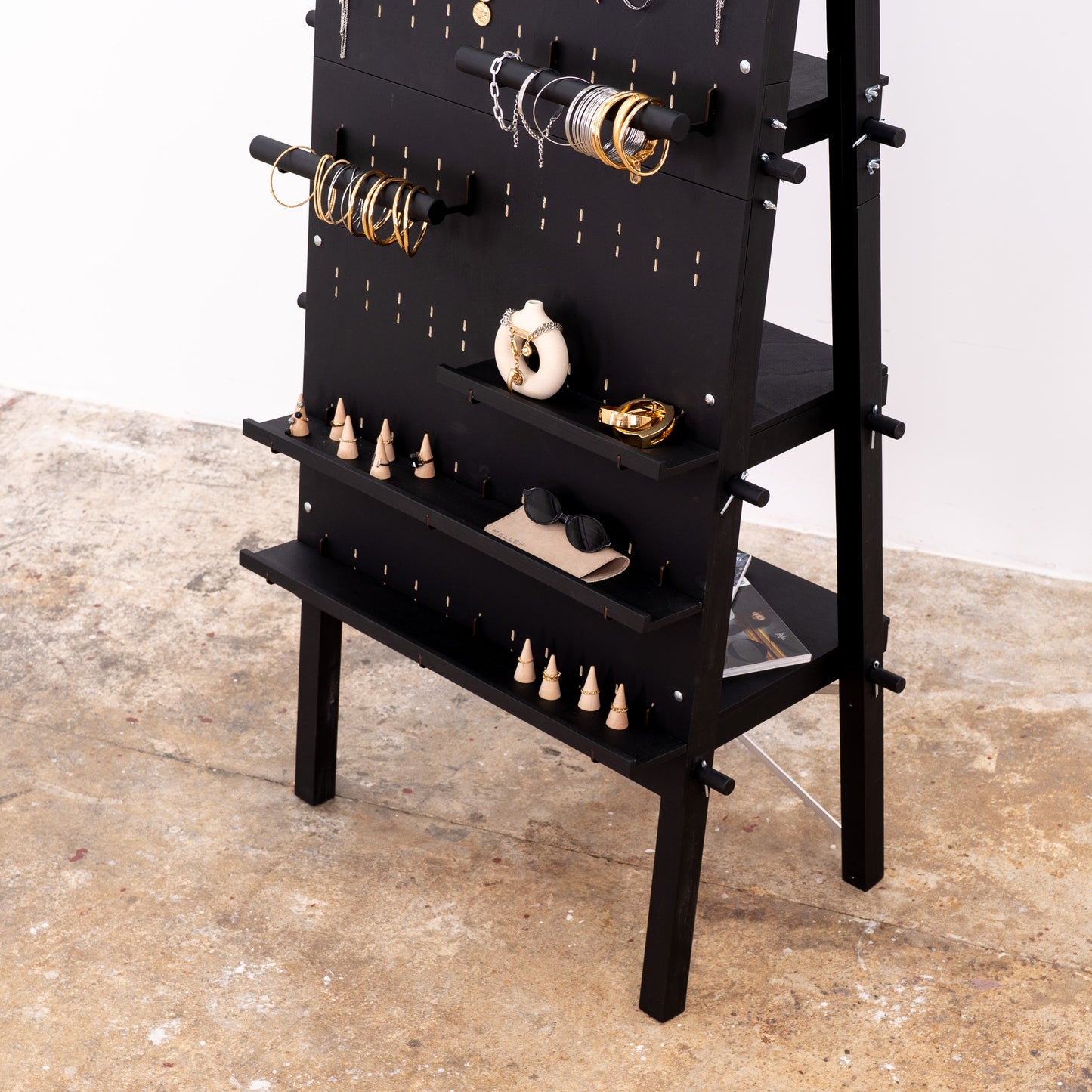 Jewelry and accessories arranged on modular pegboard system