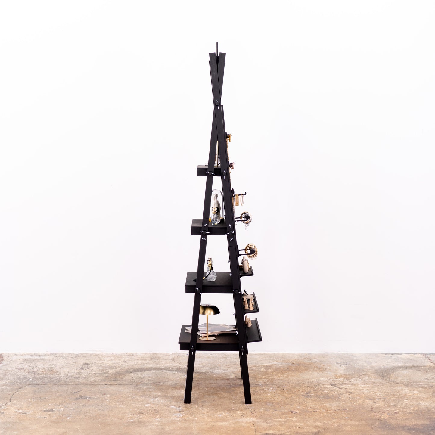 Portable black pegboard rack with minimalist layout and products