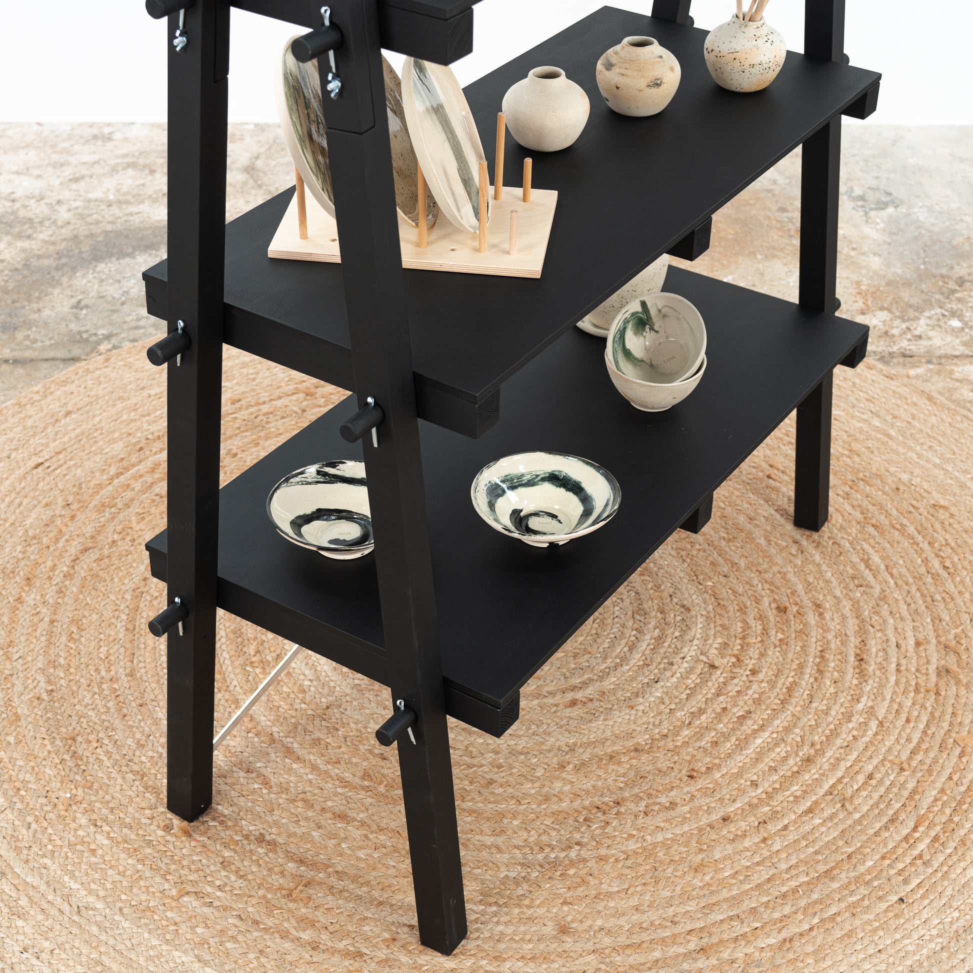 Collapsible black shelving unit with tool-free assembly for retail and event use