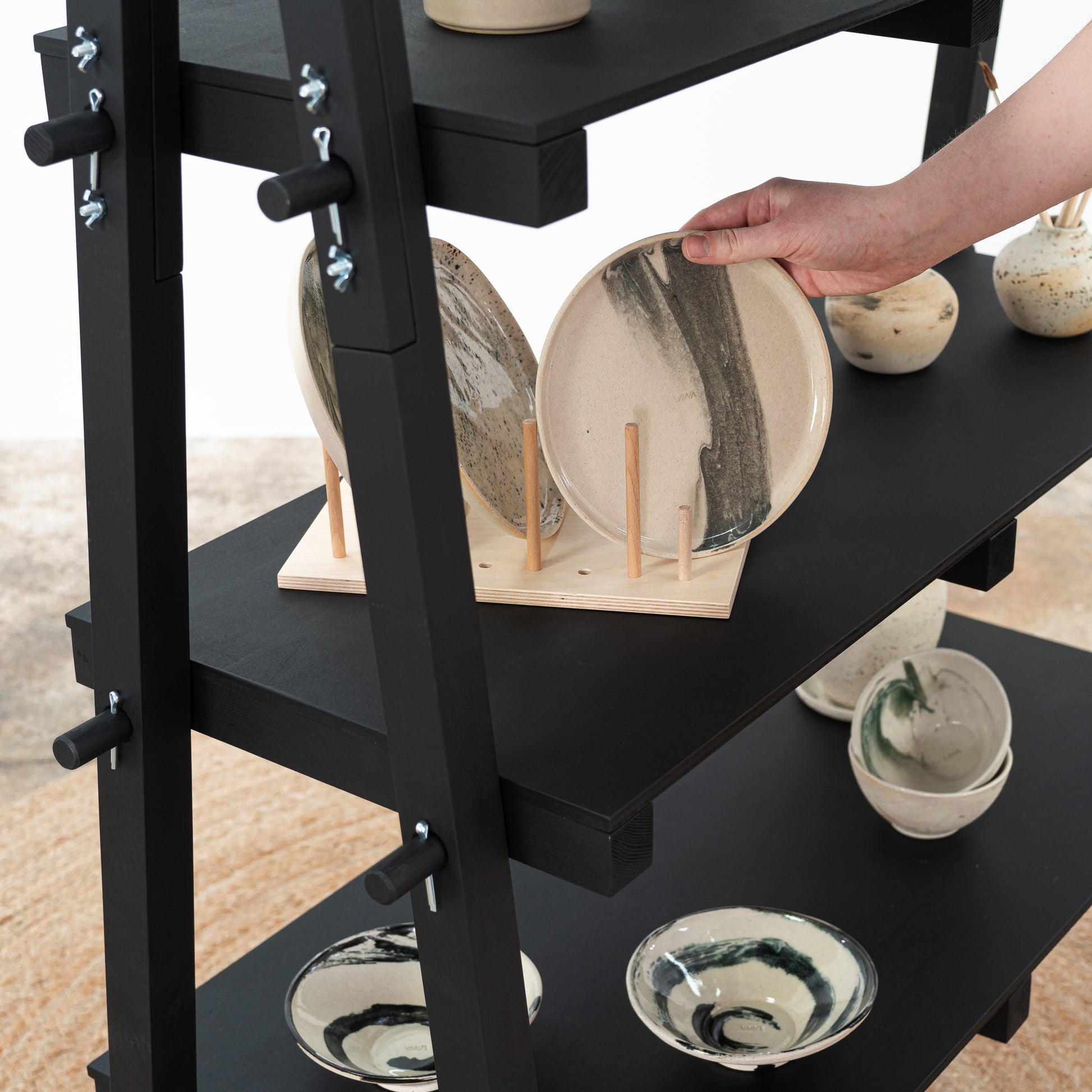 Lightweight modular black shelving system for luxury product presentations