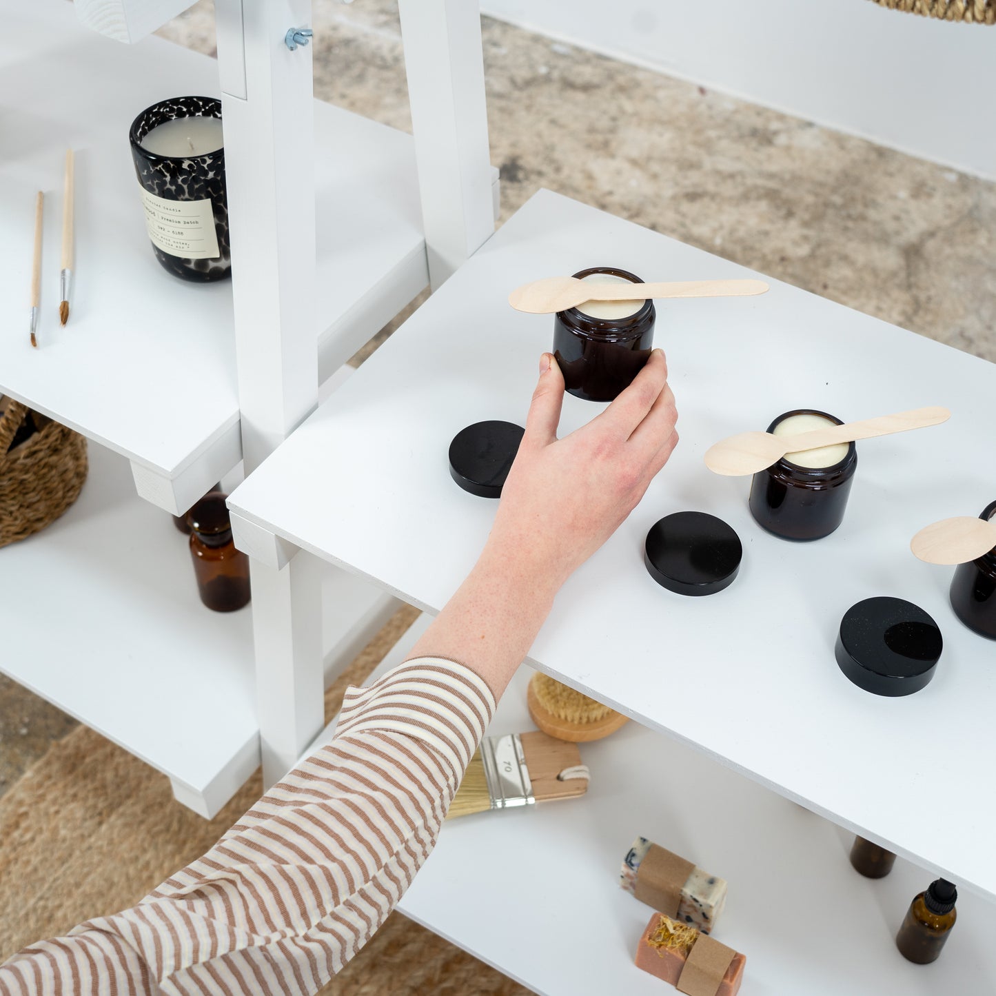 White portable shelving for showcasing beauty products and home décor