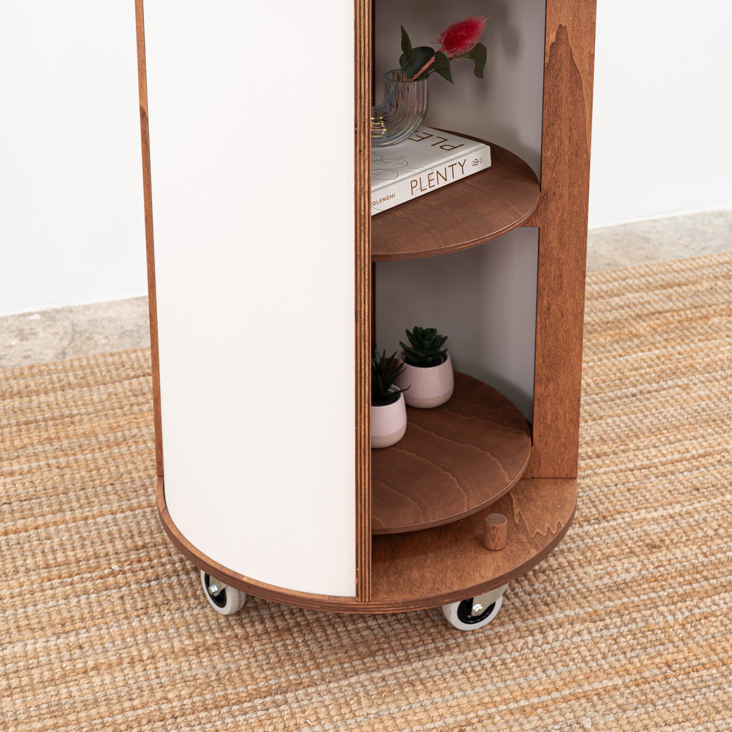 Sleek white round host stand with a polished look, designed to display products and branding at trade shows or brand activations.