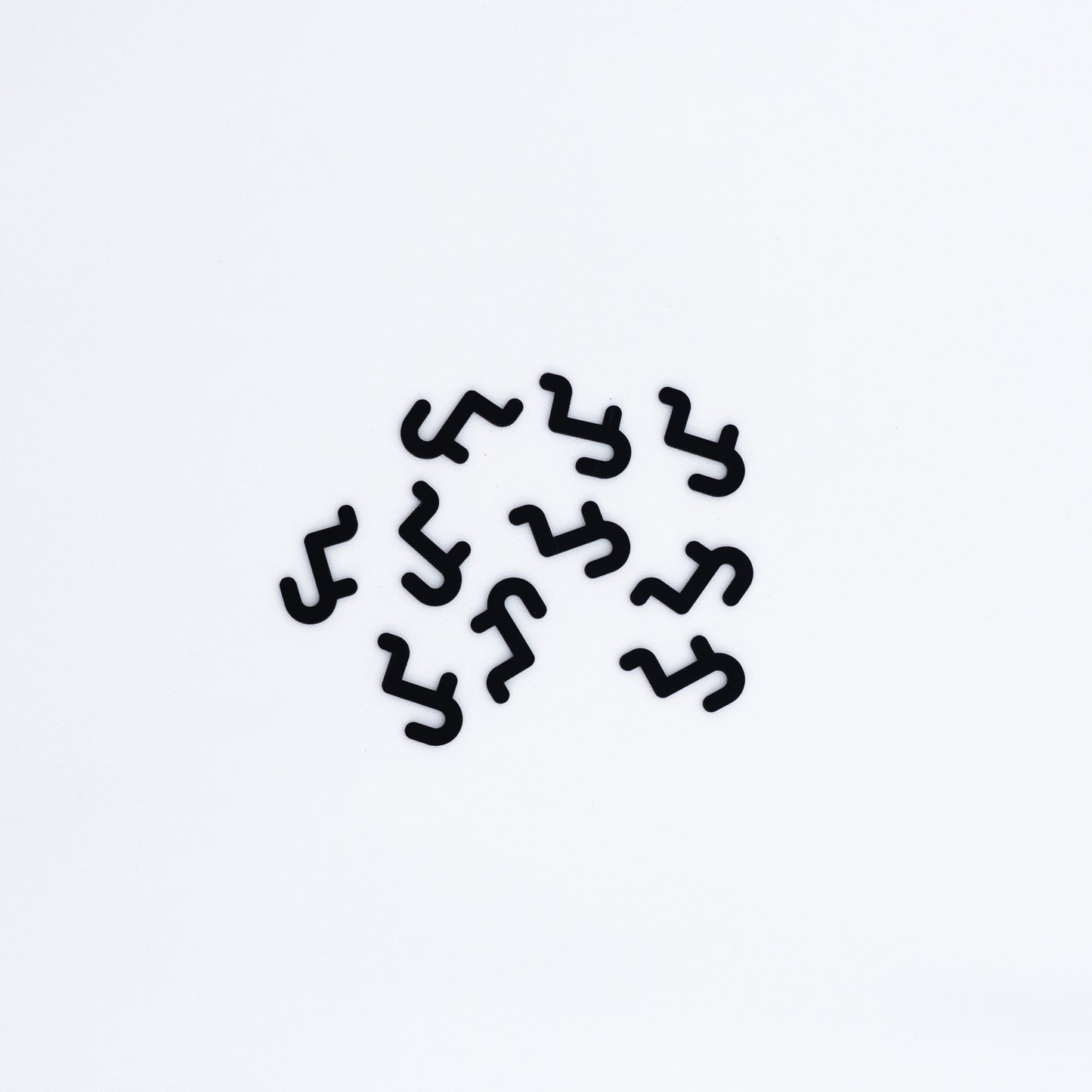 Set of 10 short hooks in black, designed for pegboards, perfect for displaying accessories, small products, and merchandise in an organized manner.