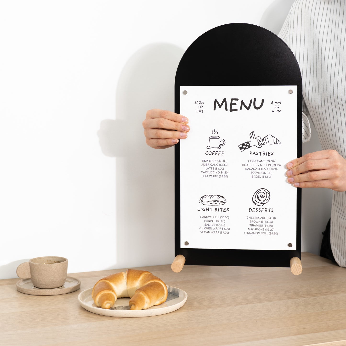 Vertical black tabletop sign with arched top and wooden feet