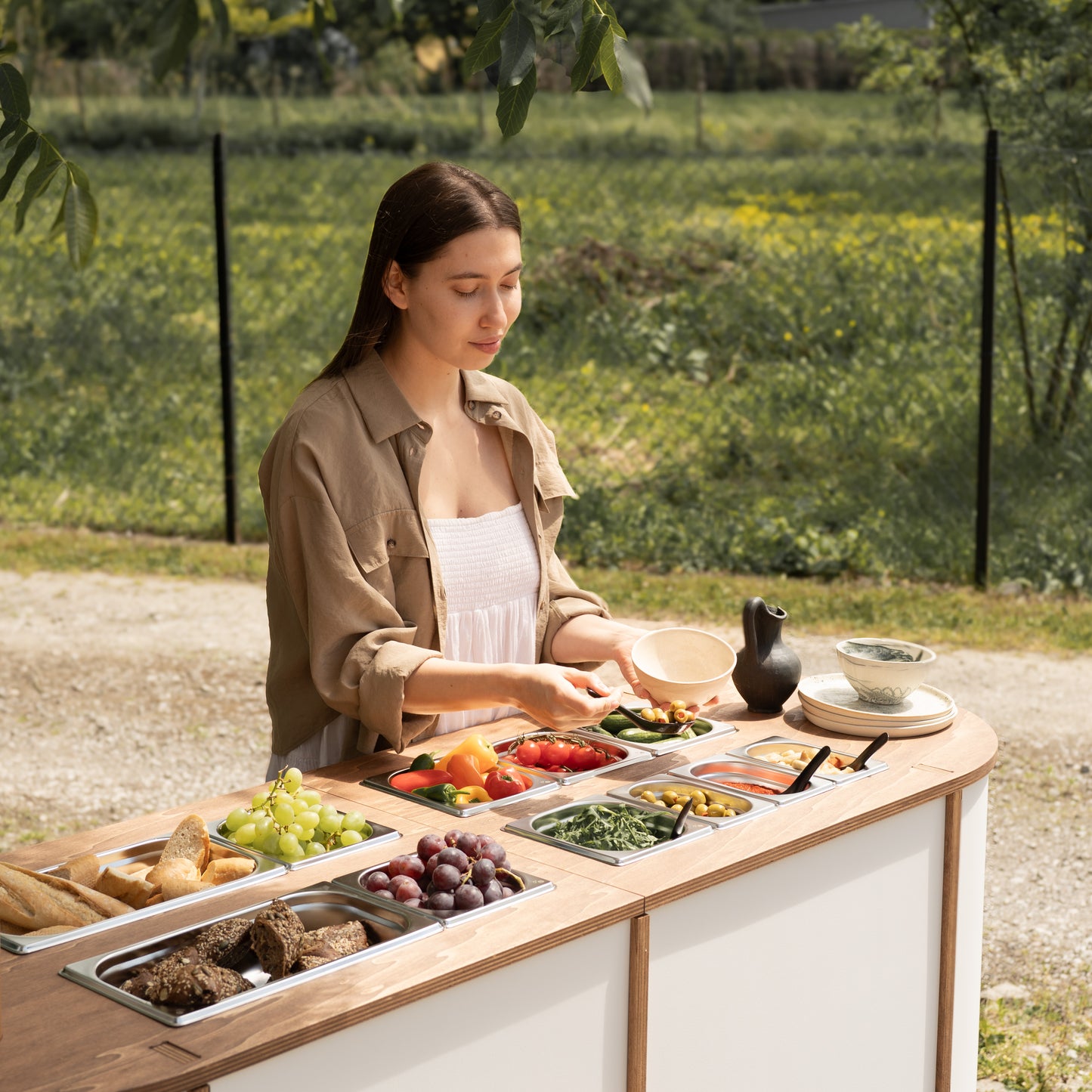 Outdoor catering station with umbrella and snack bar setup