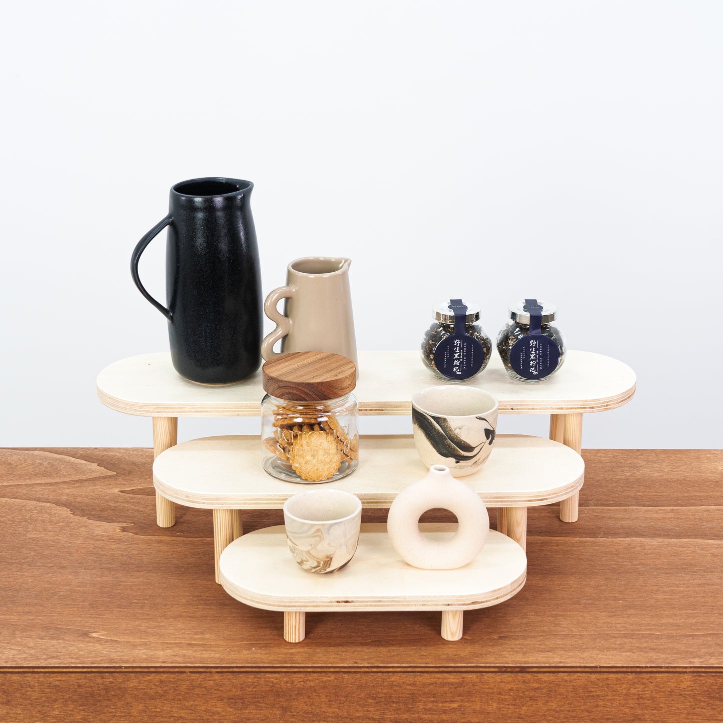 Natural wood riser set showcasing handmade candles and accessories