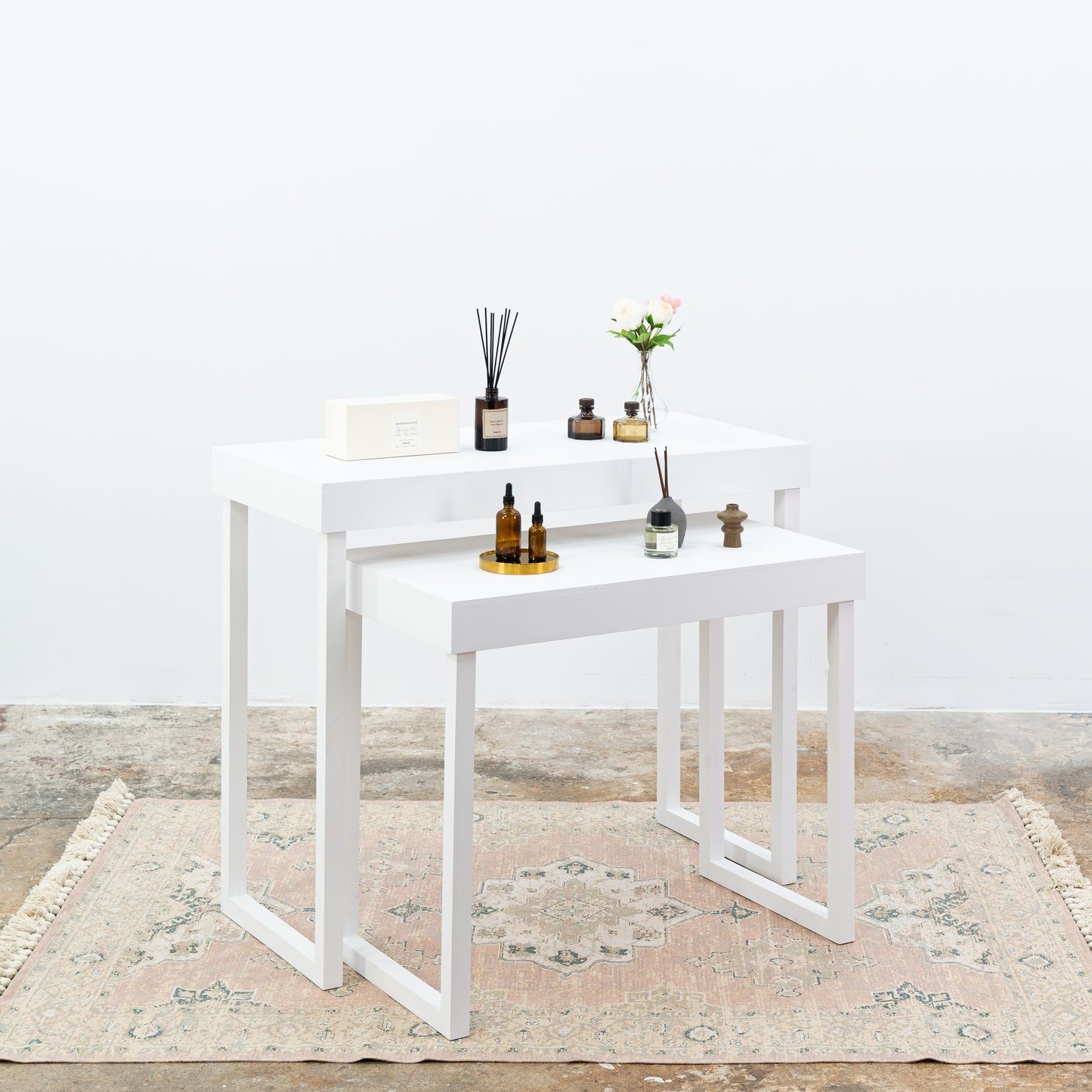 Elegant white vendor tables for beauty and boutique setups