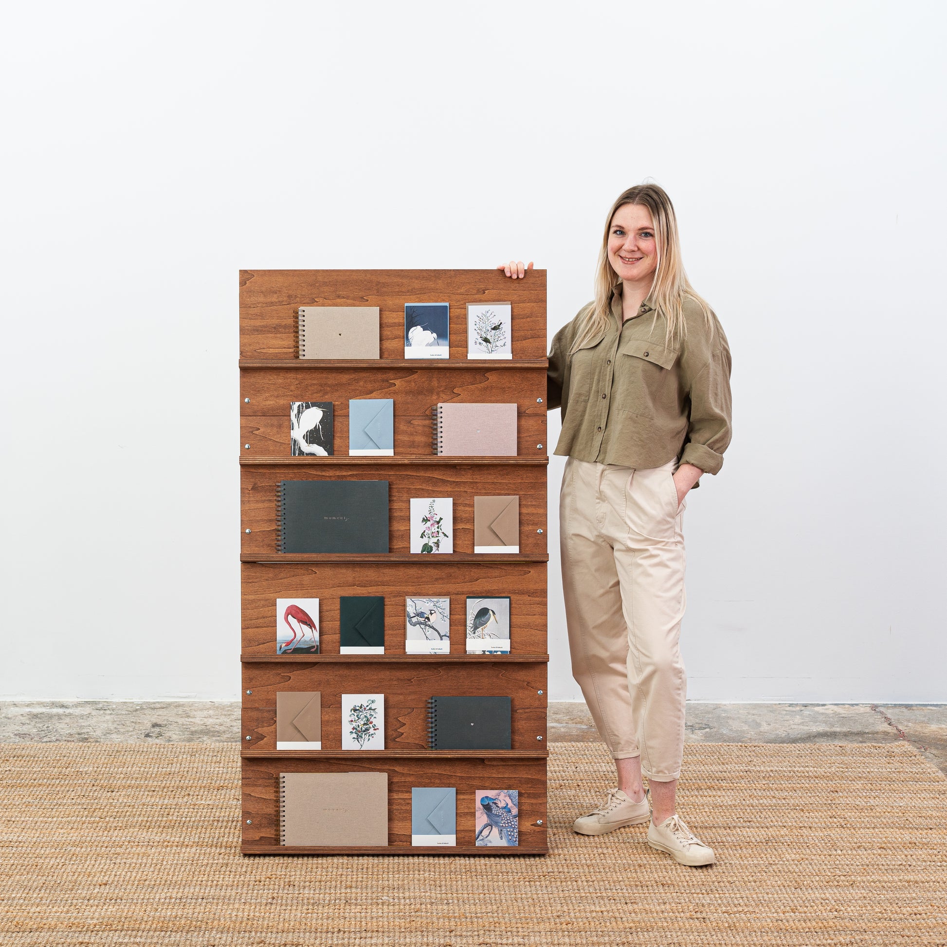 Collapsible magazine rack in coffee finish shown from the side