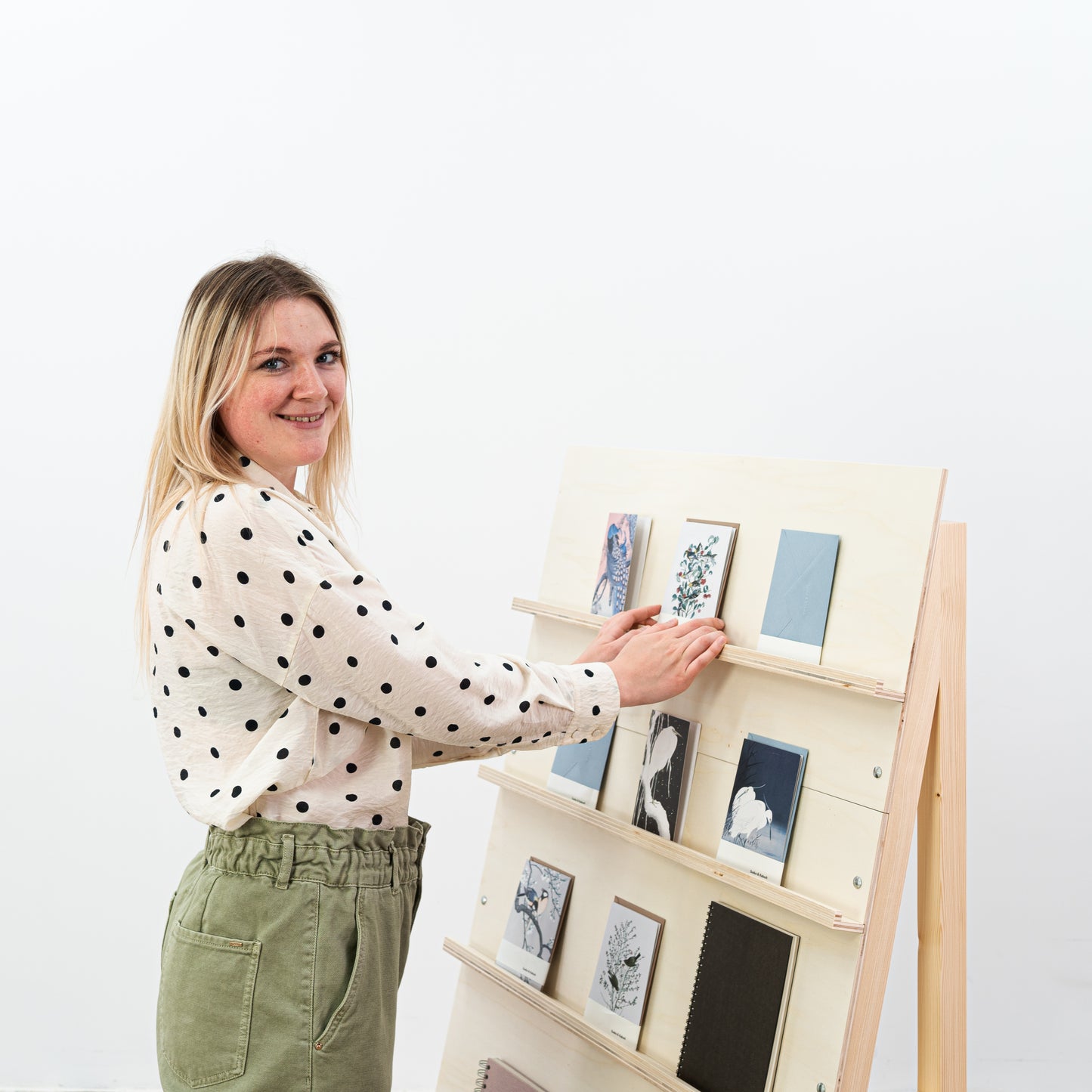 Portable wooden shelving unit used at a craft fair