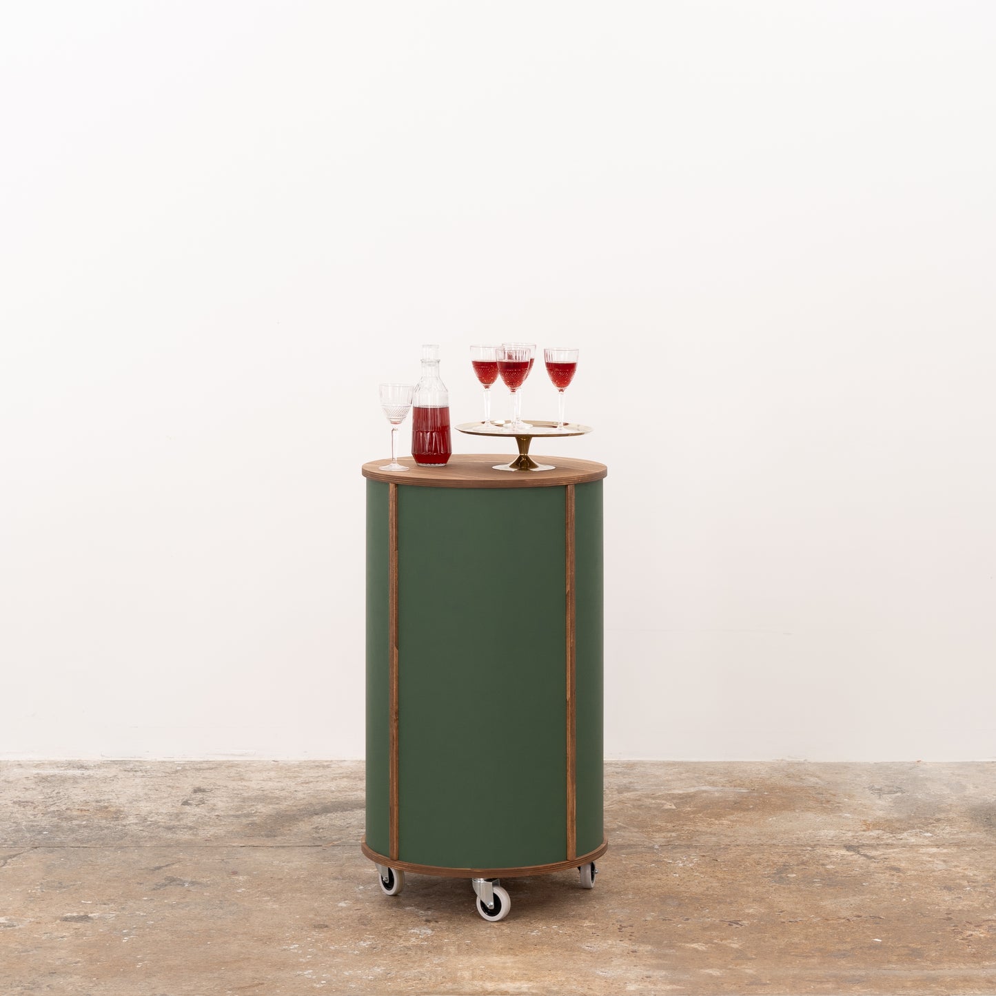Green round host stand designed for easy organization and functional use, offering a modern setup for events and retail environments.