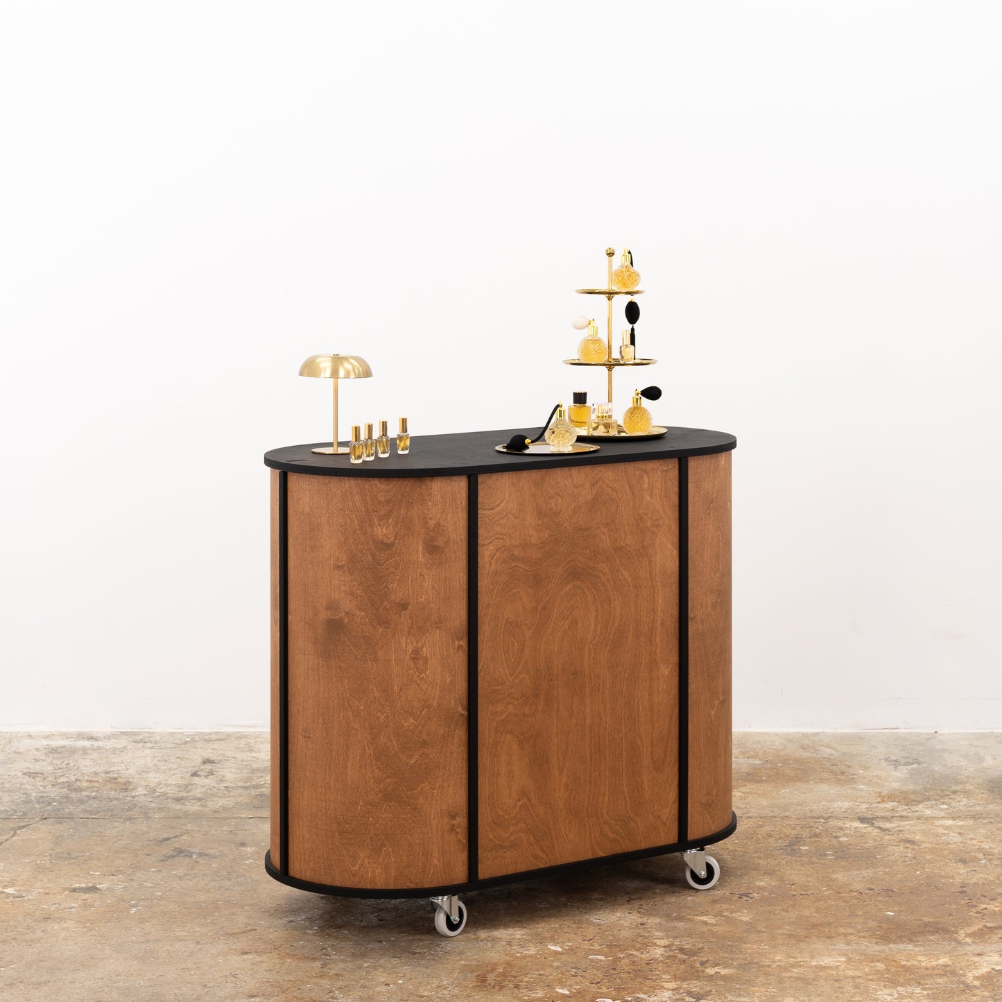 Customizable oval counter with large storage compartments for product organization.