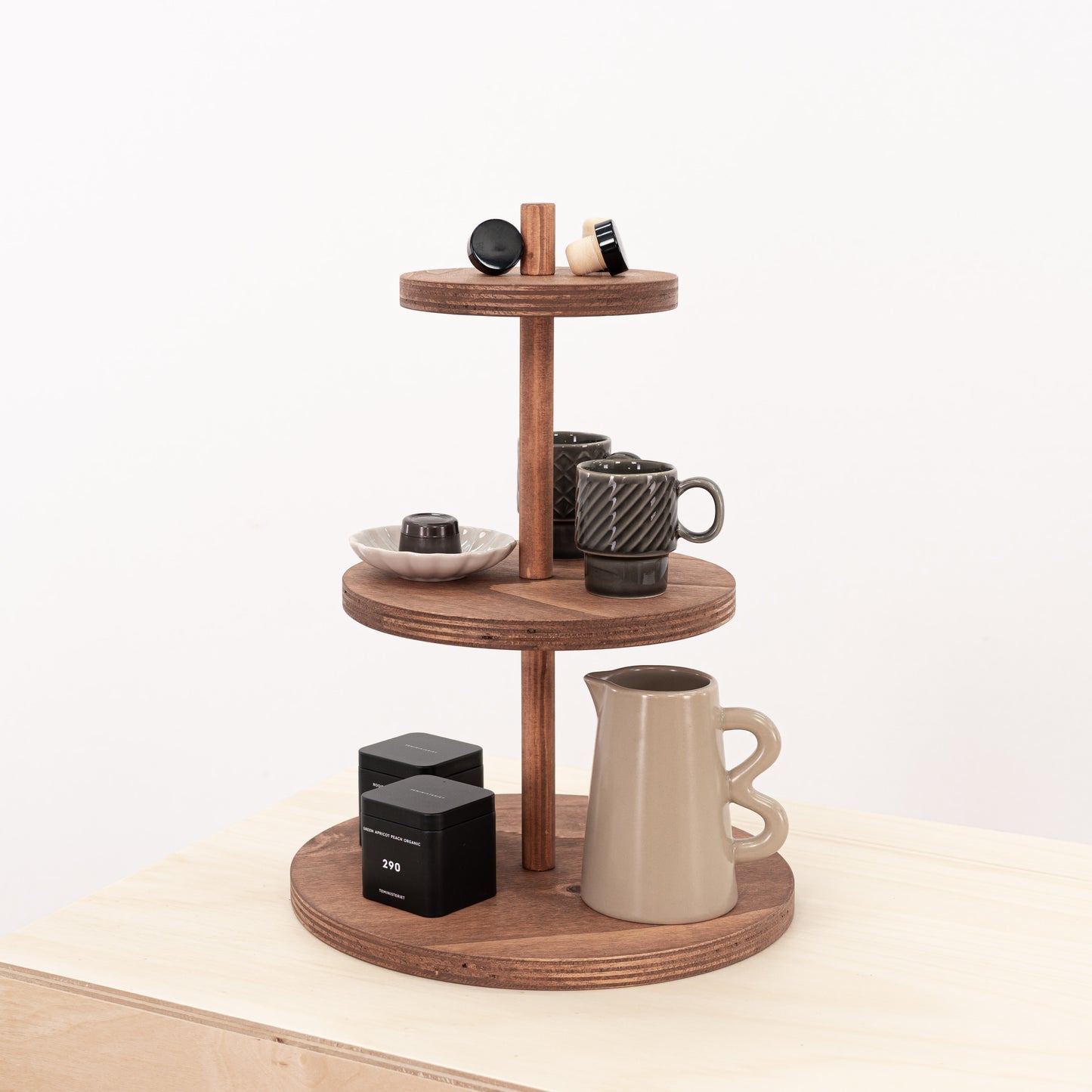 Coffee color three-tier riser with varying tier sizes, perfect for displaying jewelry, perfumes, and cosmetics.