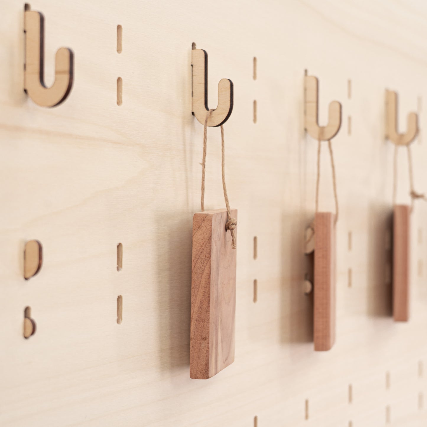 Set of 10 short, sturdy hooks designed for pegboards, ideal for creating customized displays for events and shops.