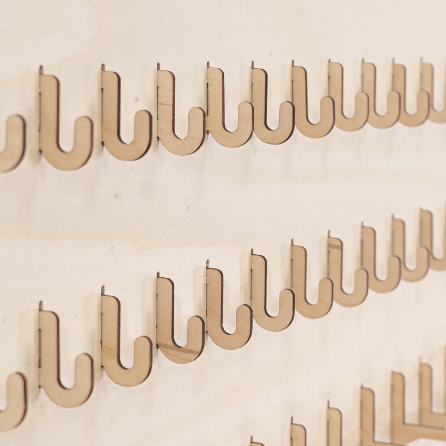 Set of 10 short hooks for pegboards, designed for organizing small products and accessories in retail and event displays.