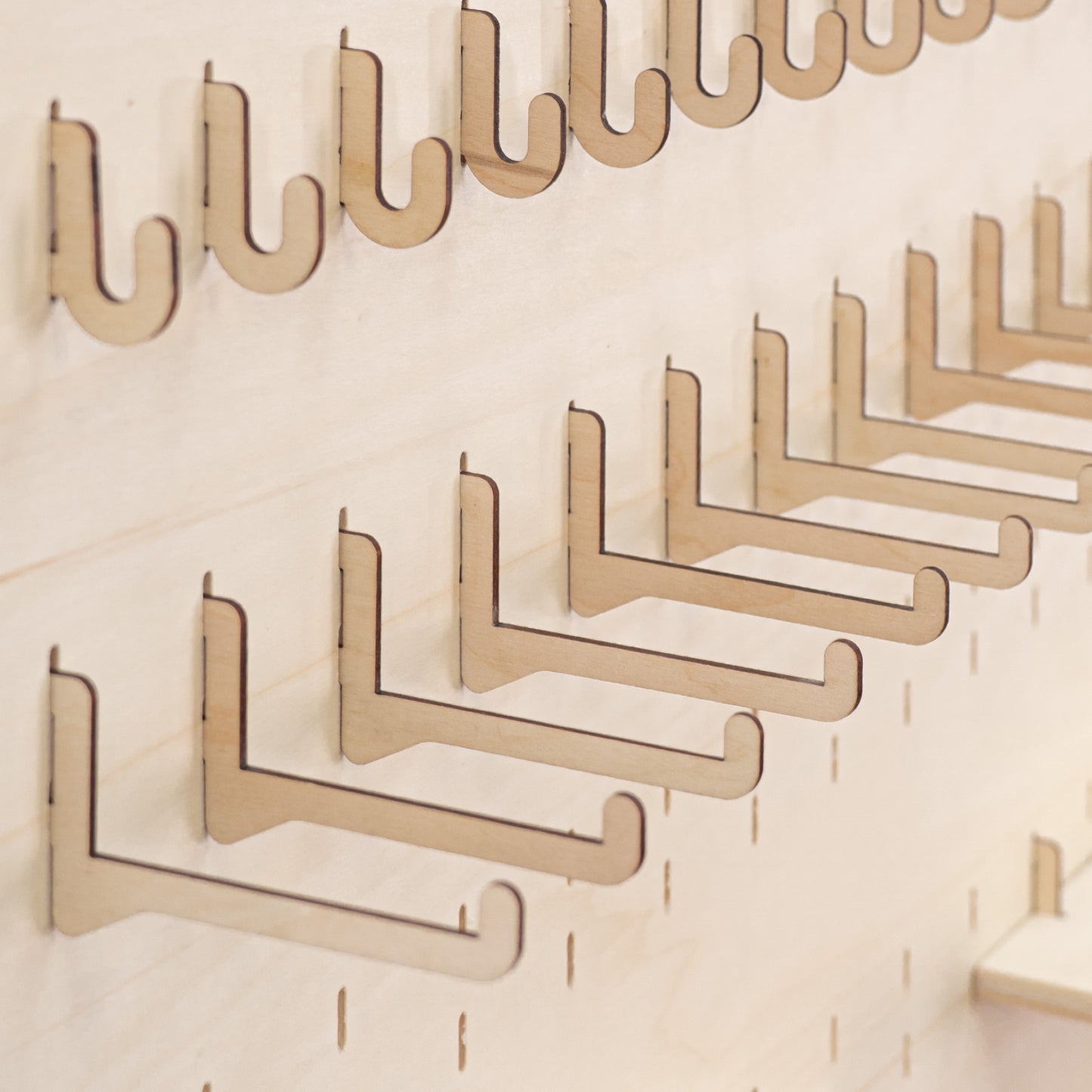 Pack of 10 long hooks for pegboards, offering an elegant and practical solution for showcasing large items like apparel and decor.