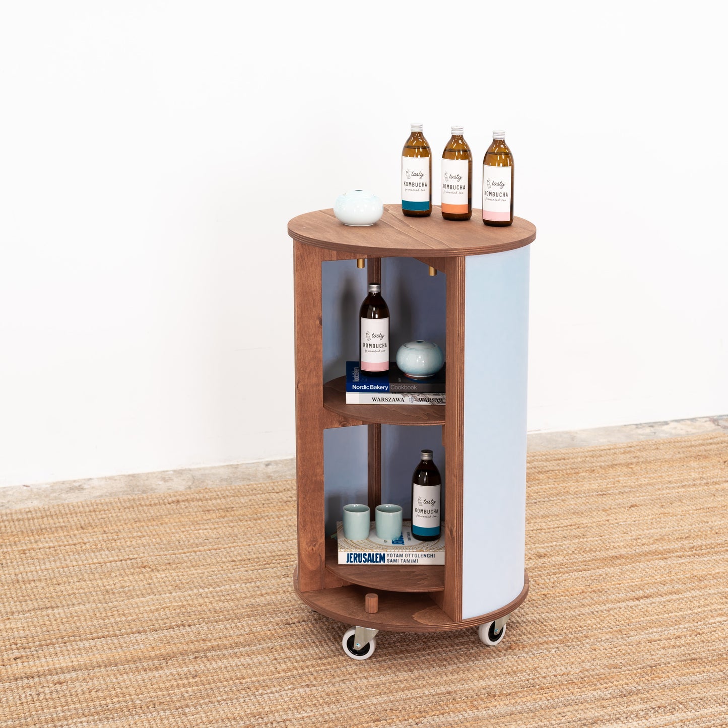 Round host stand with minimalist design and spacious shelves, perfect for organizing and displaying products at events.