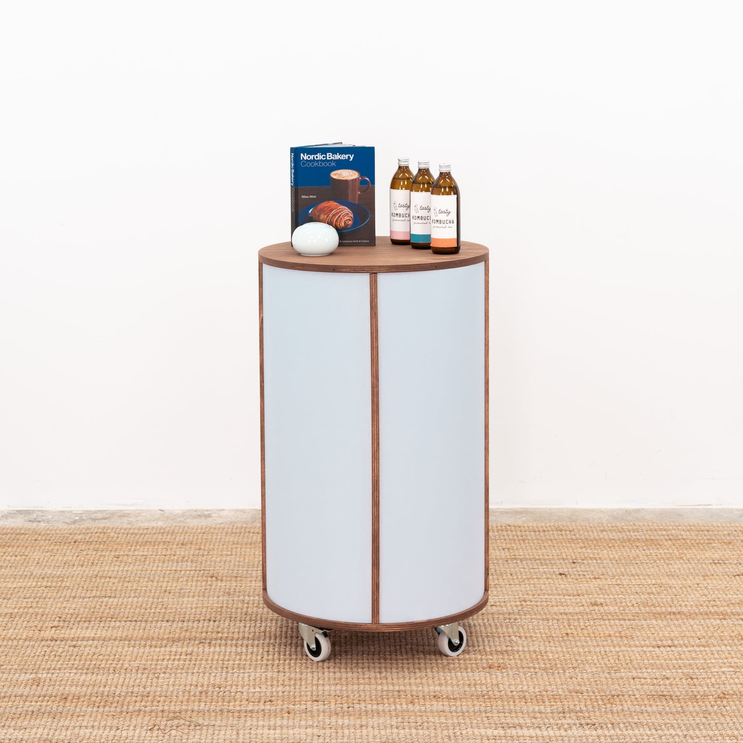 Wooden round host stand with a sleek design and open shelving, ideal for organizing and displaying items.