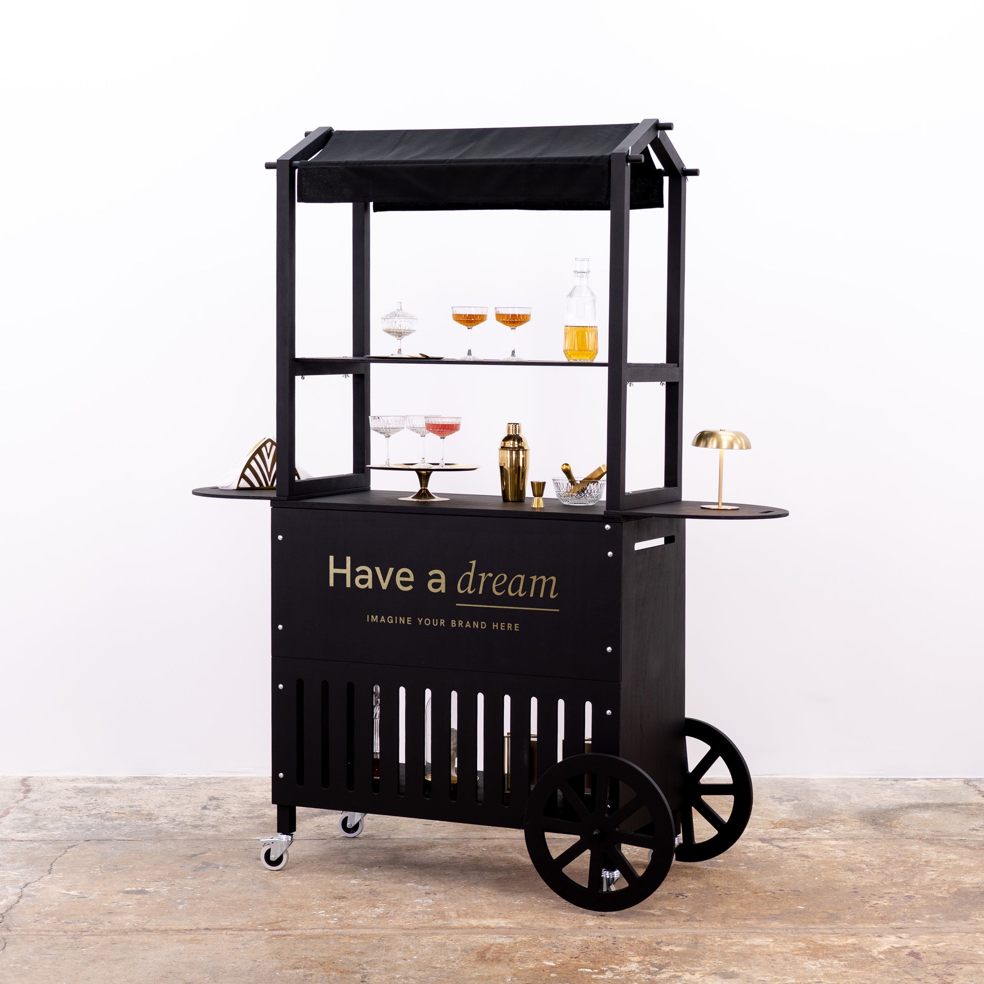 Stylish black beverage cart with branded front and decorative items, perfect for events and trade shows.