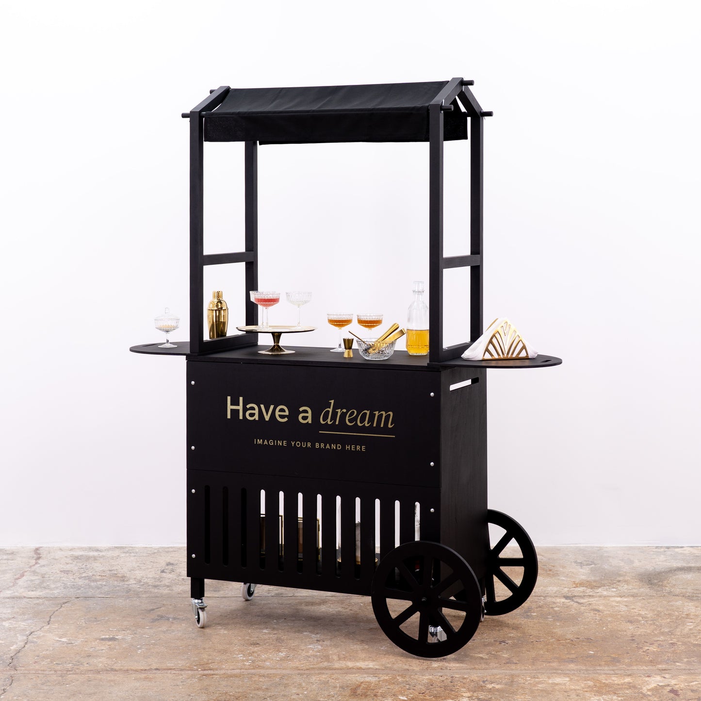 Black mobile cart with elegant shelving and custom branding, perfect for serving drinks at events.