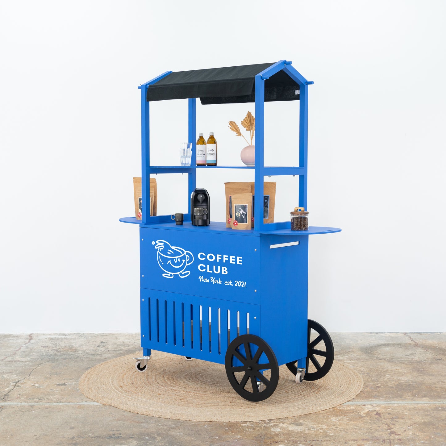 Cobalt blue cart with black awning – Coffee School branding