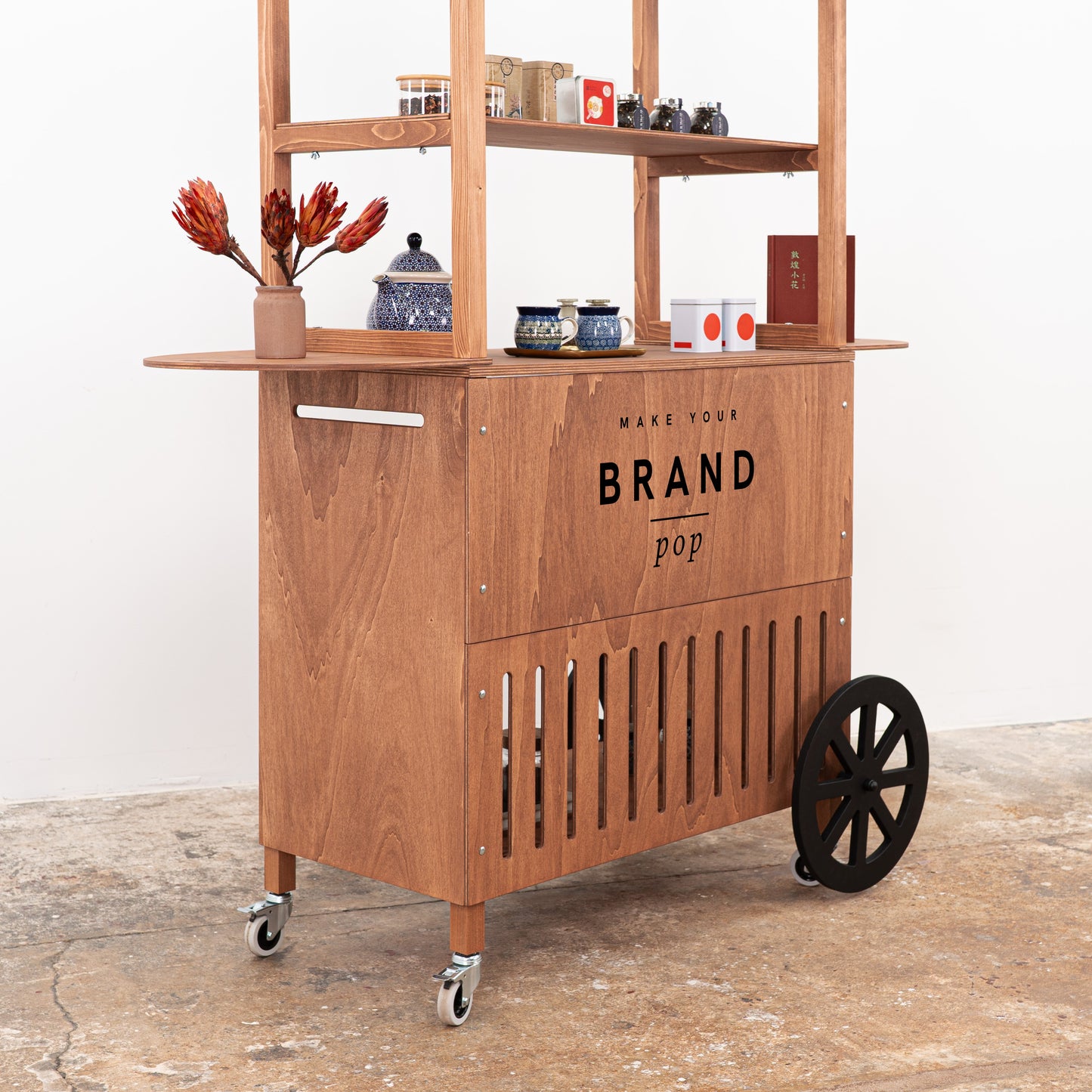 Mobile handcrafted vendor cart with shelving and elegant finish