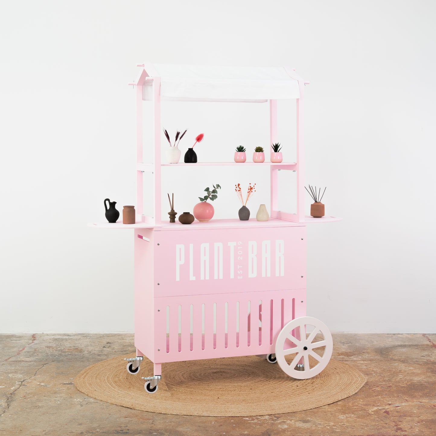 Soft pink cart with white accents – beauty and makeup product display