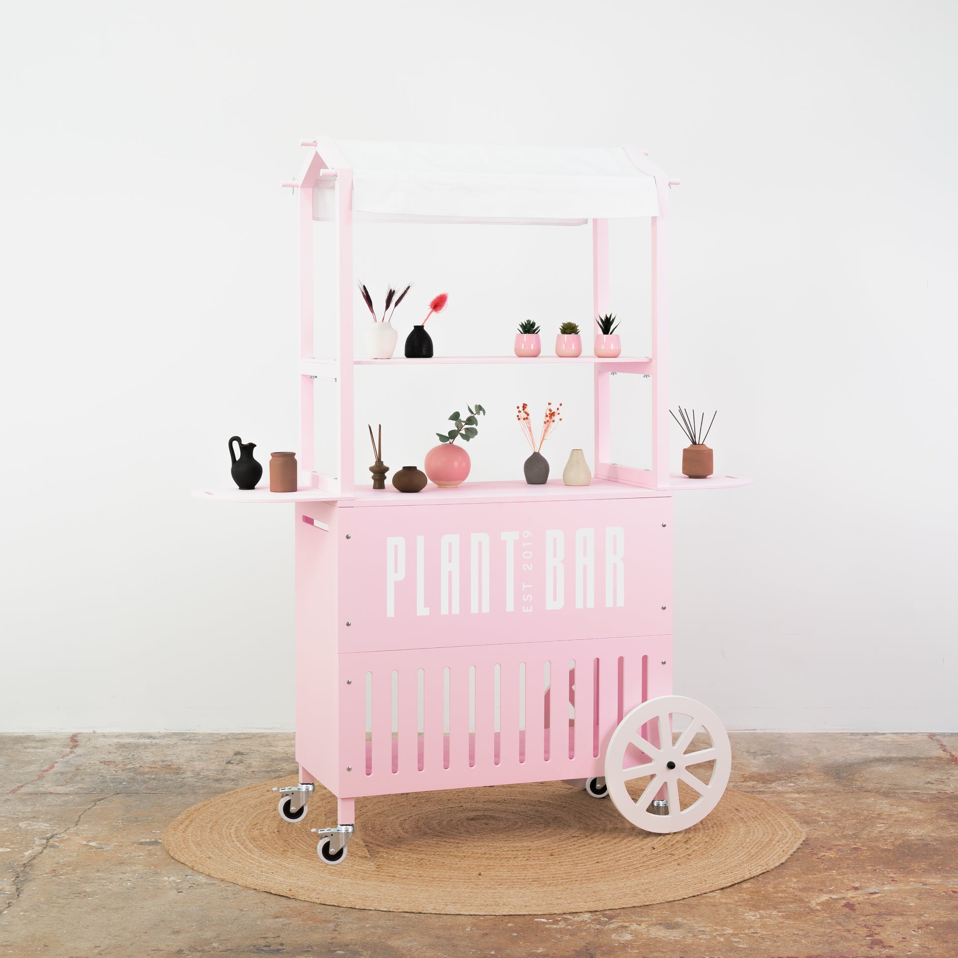Soft pink cart with white accents – beauty and makeup product display