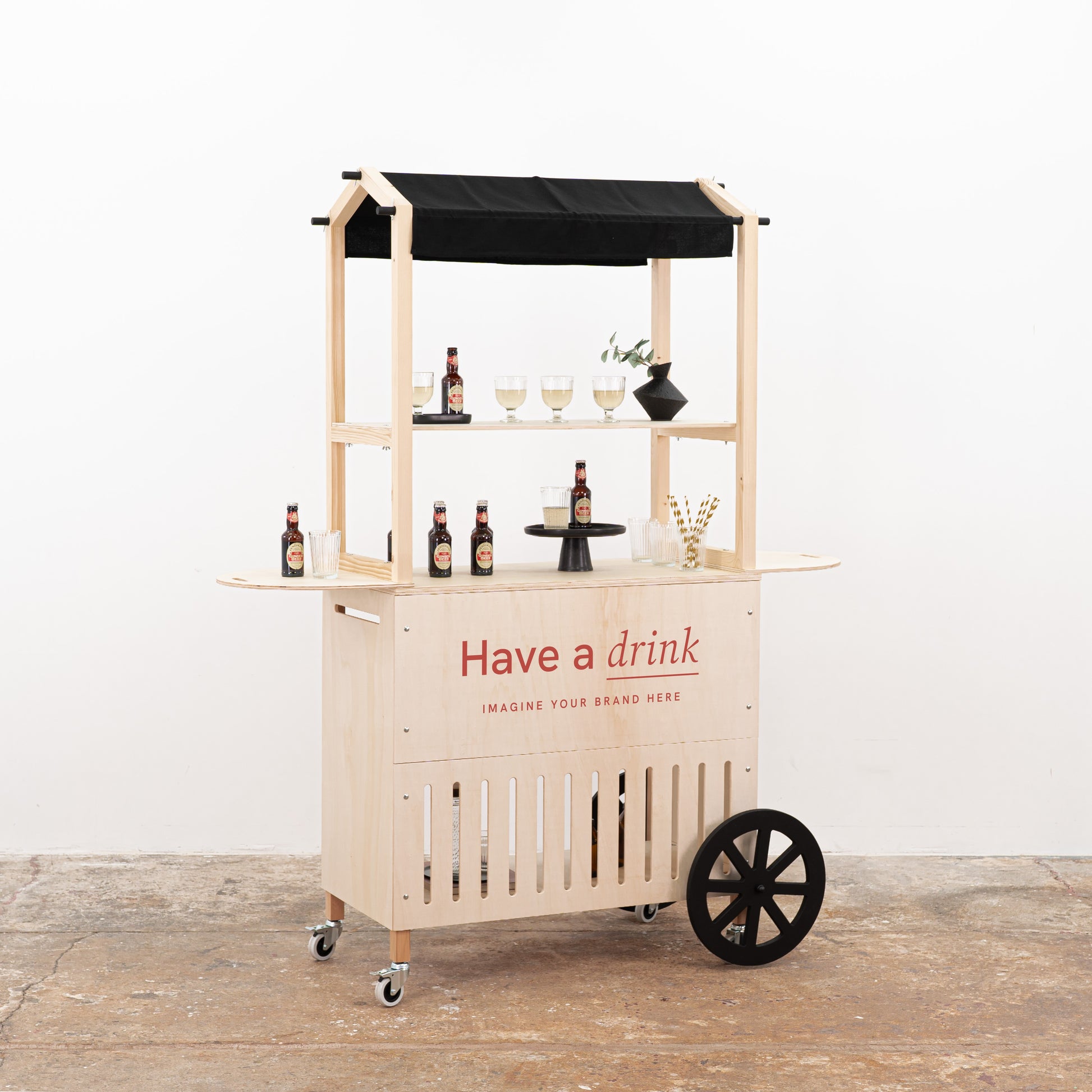 Foldable wooden drink cart with black awning and branded front panel