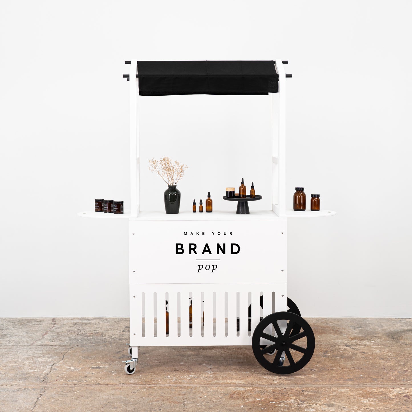 White mobile cart with a sleek design and branded logo, ideal for showcasing beauty products at events and pop-up shops.