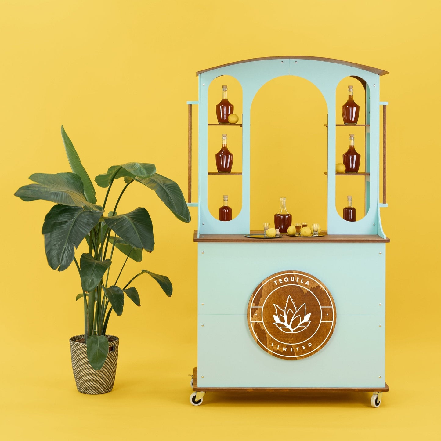 wagon bar cart with arched display and branded logo on yellow background