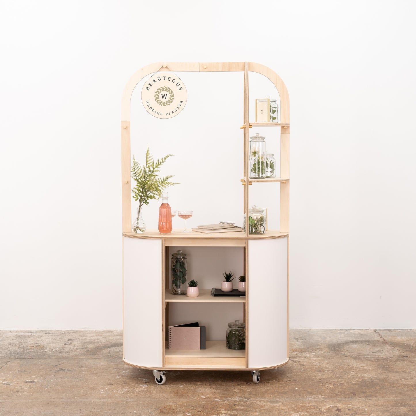 Oval merchandising cart with storage compartments
