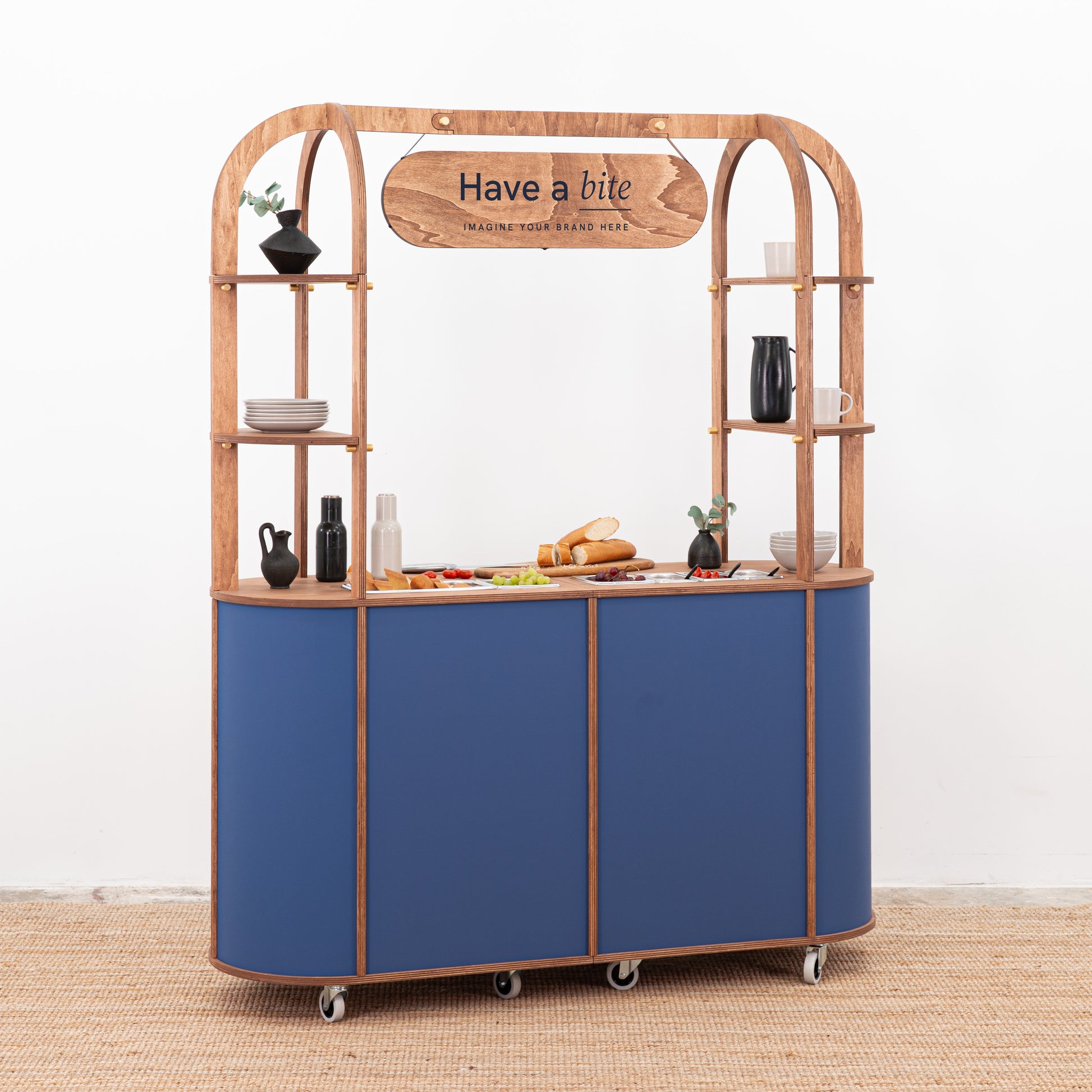Professional charcuterie booth with logo board and bain-maries for serving