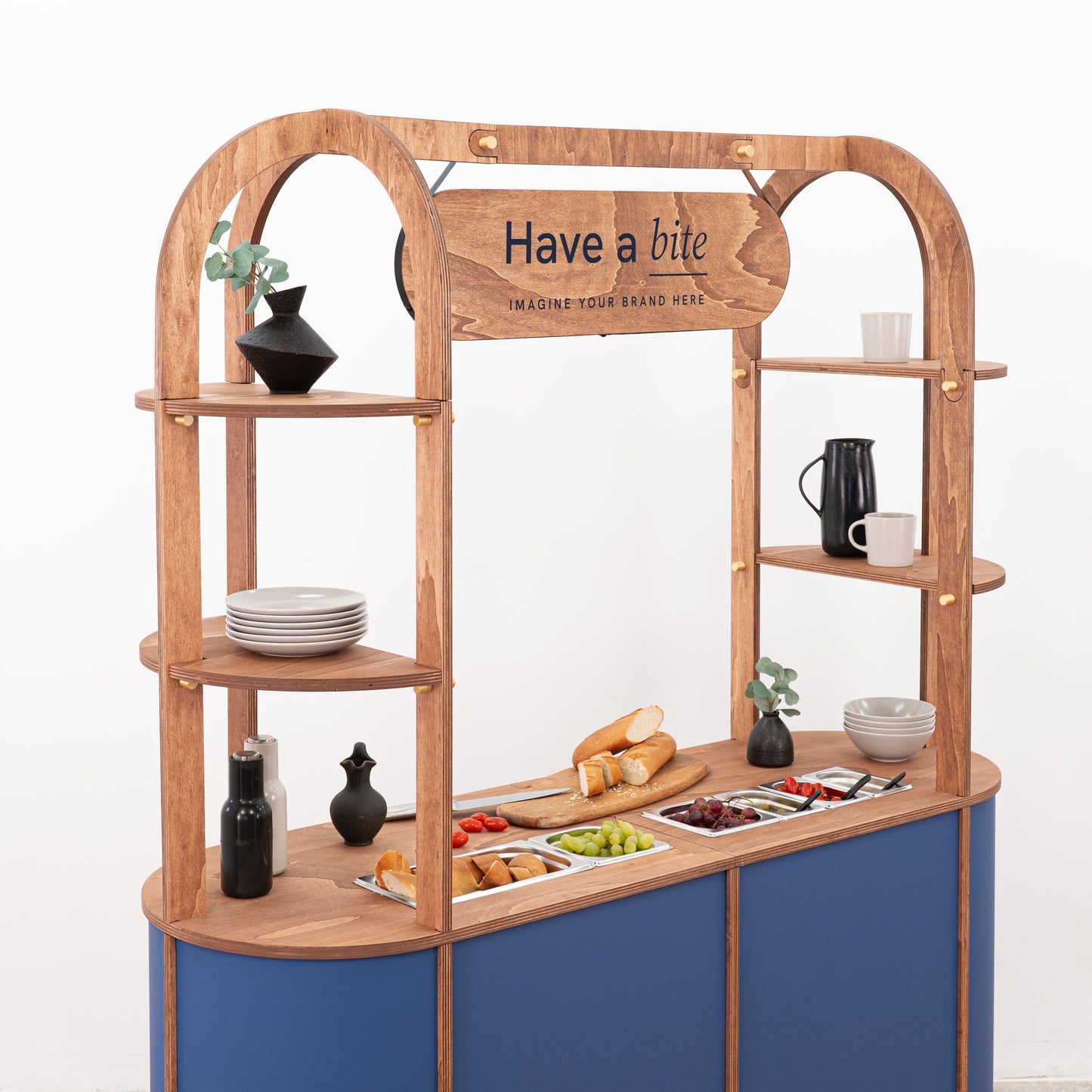Wooden display cart for event catering with open shelving and logo