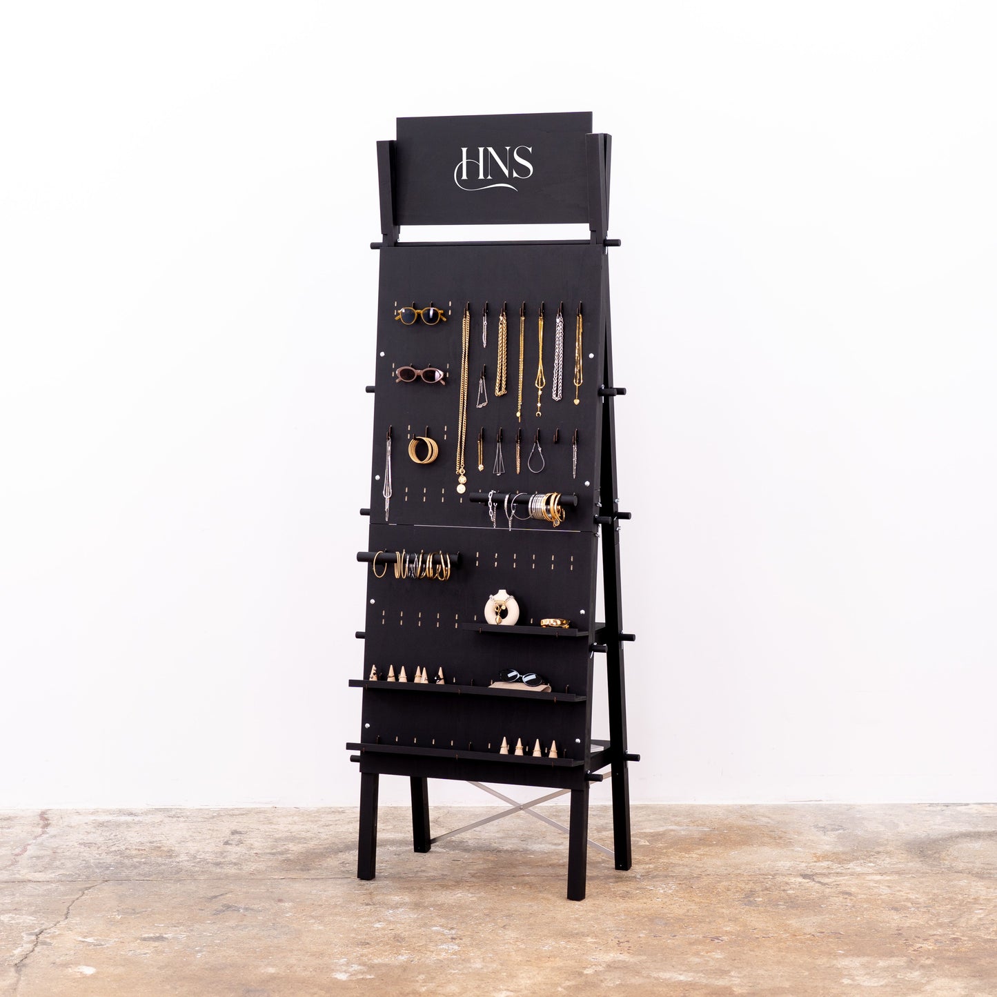 Matte black A-frame pegboard display stand with hooks