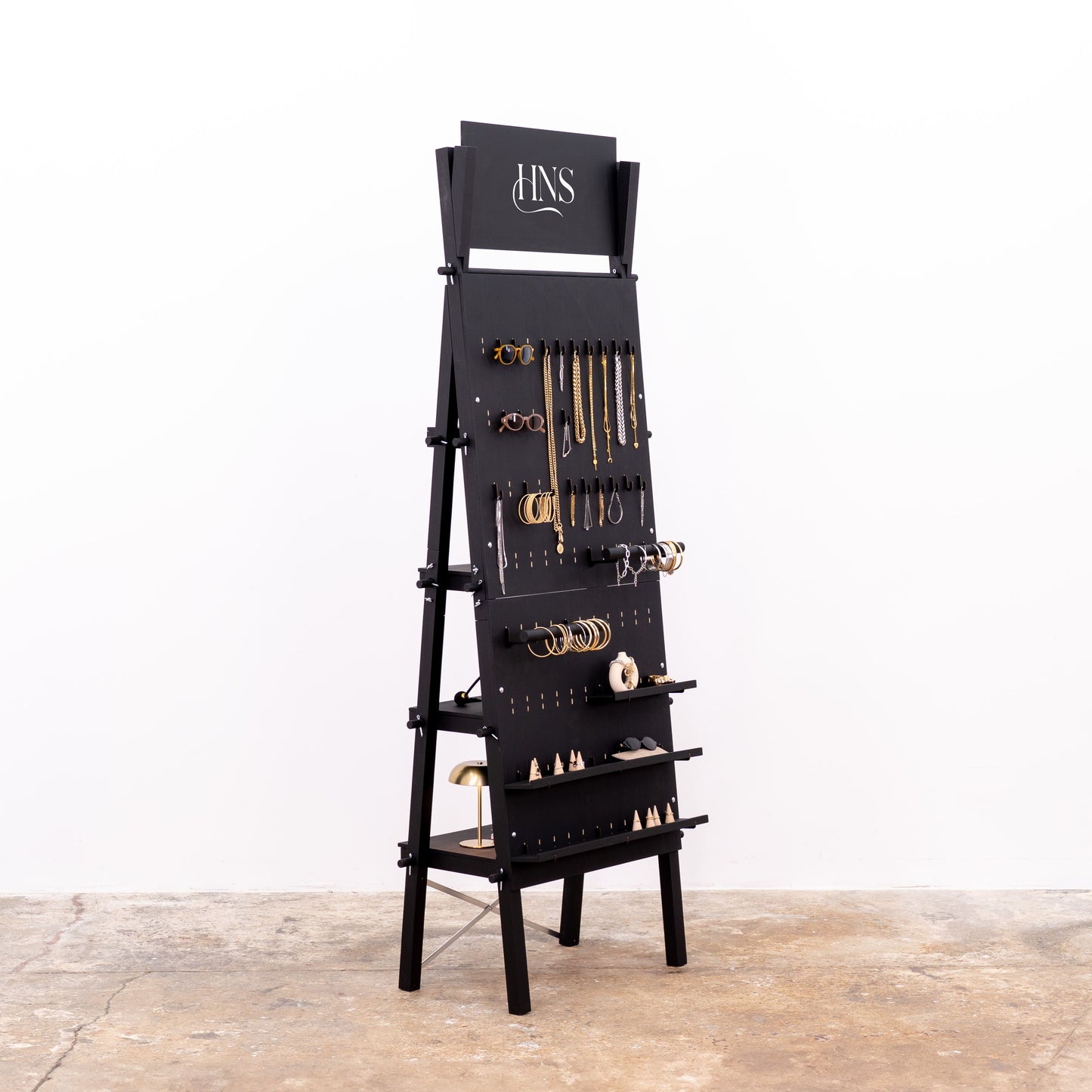 Matte black pegboard with adjustable hooks and rear shelf system