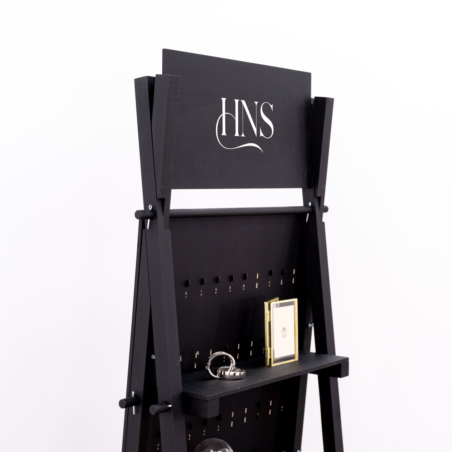 Pegboard unit with bottom shelf for props and packaging