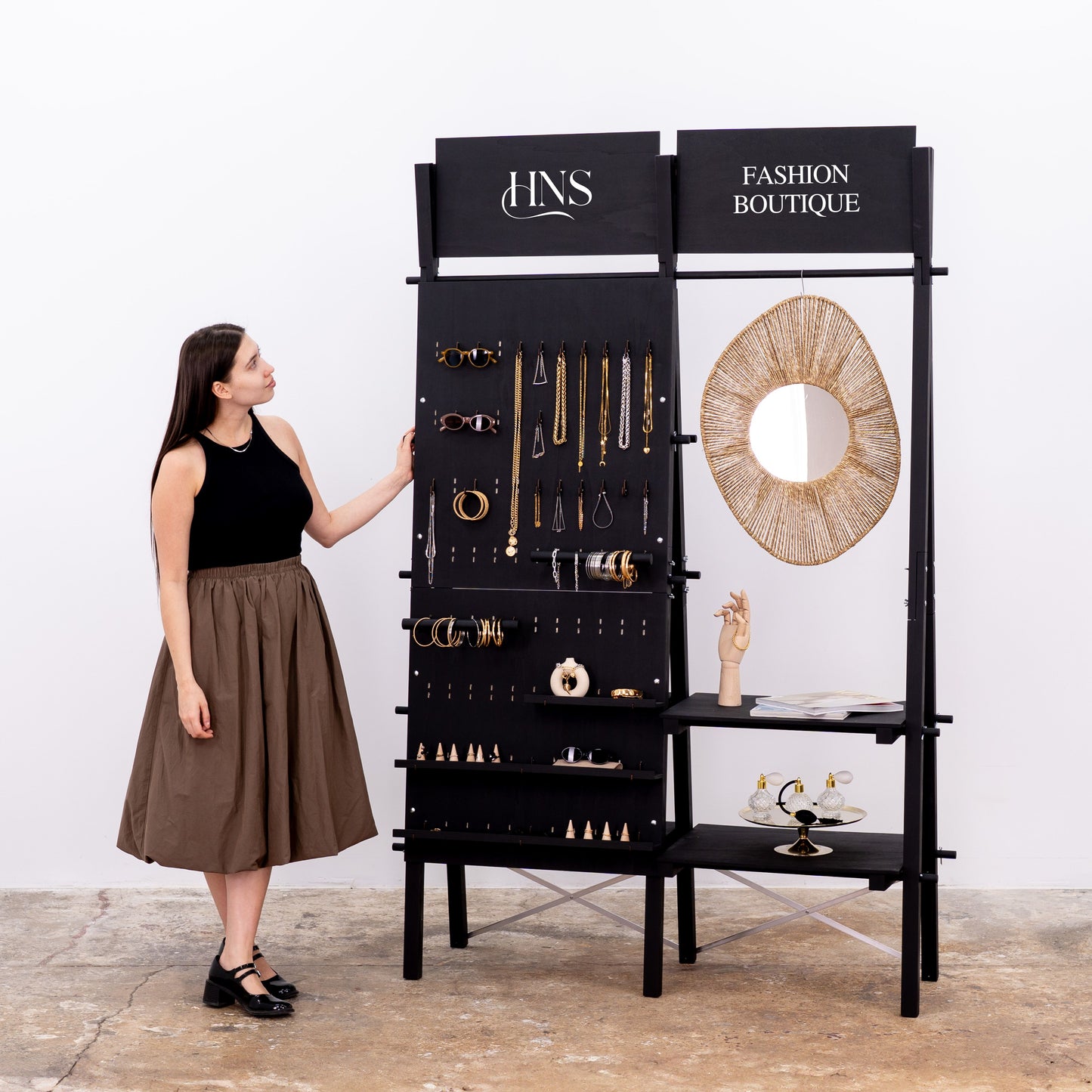 Double-sided pegboard and shelving display with hanging rail and logo panels