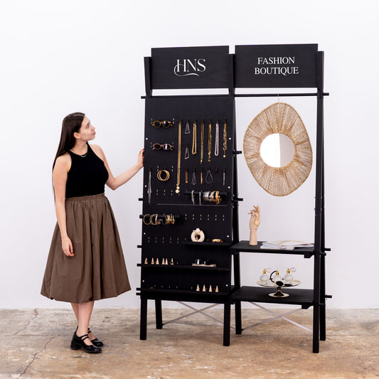 Double-sided pegboard and shelving display with hanging rail and logo panels
