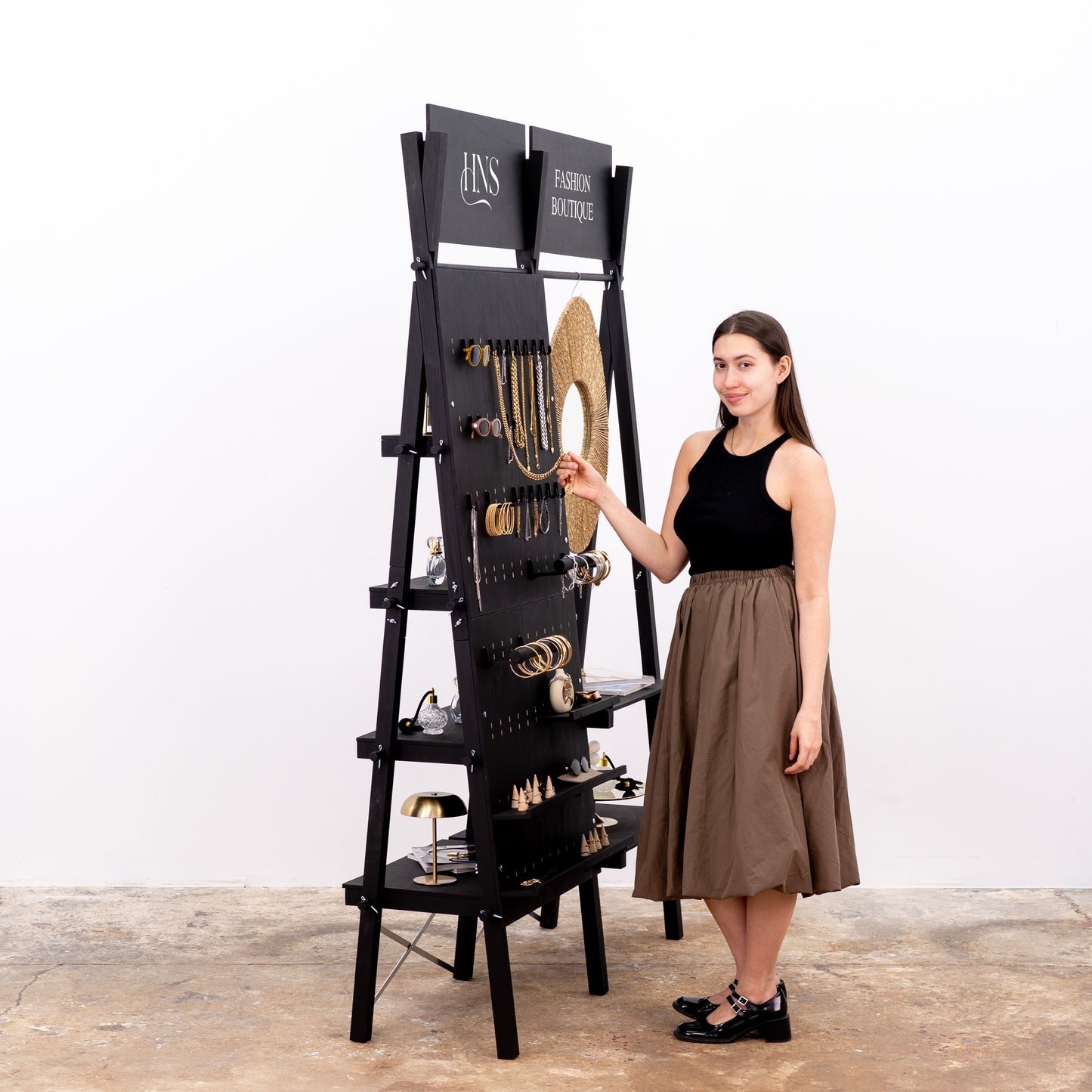 Boutique display unit with pegboard and product staging shelves