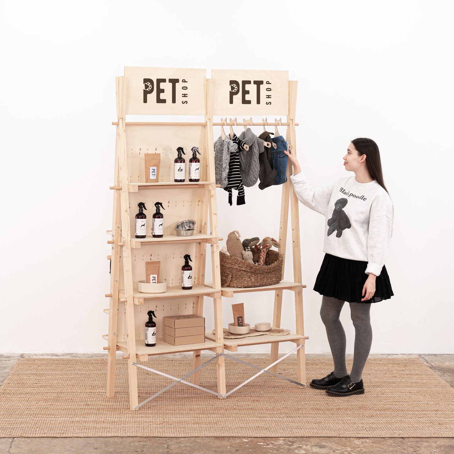 Modular wooden display rack with pegboard, shelves, and clothing rail for trade fairs