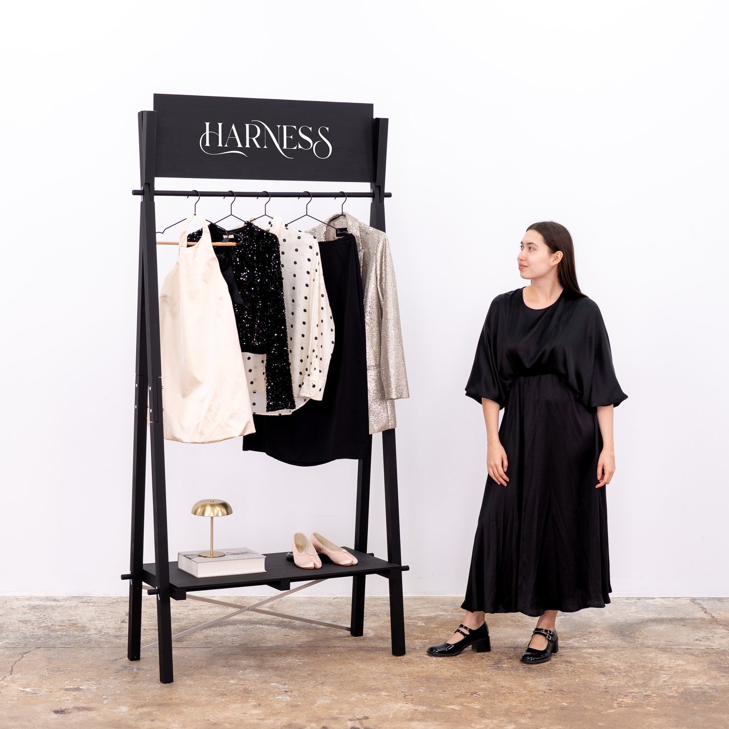 Portable fashion rack in matte black finish with elegant clothing setup