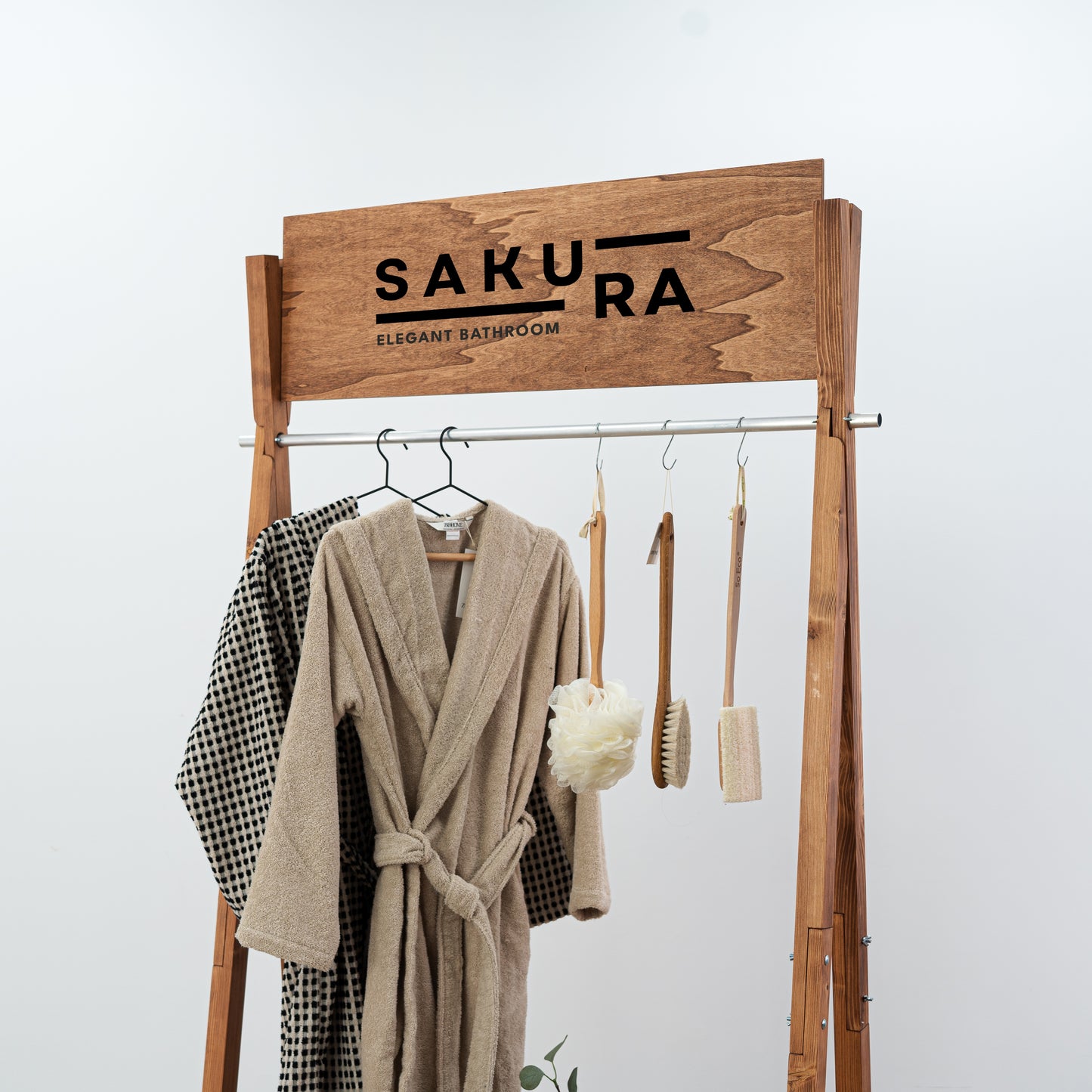 Portable A-frame retail rack in warm wood tone with folded items on bottom shelf