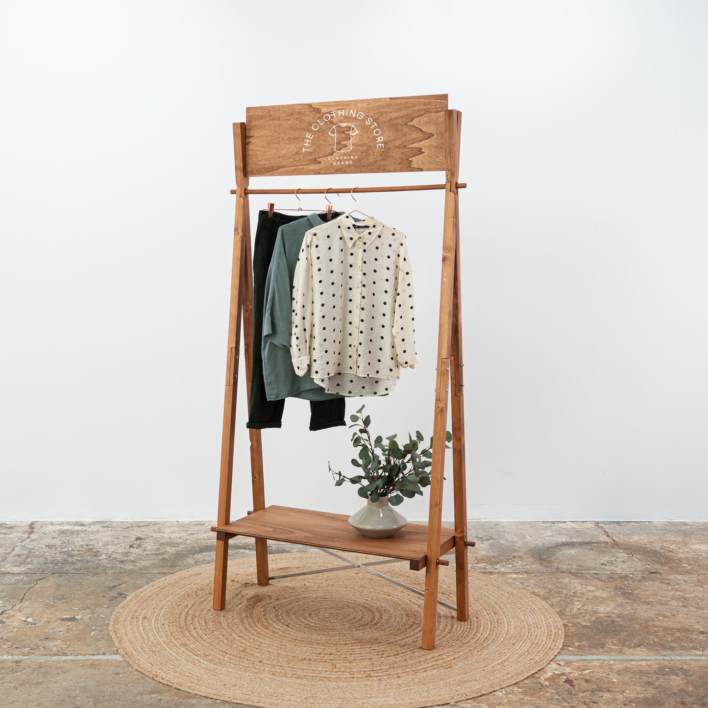 Custom retail stand for garments and shoes with personalized signboard
